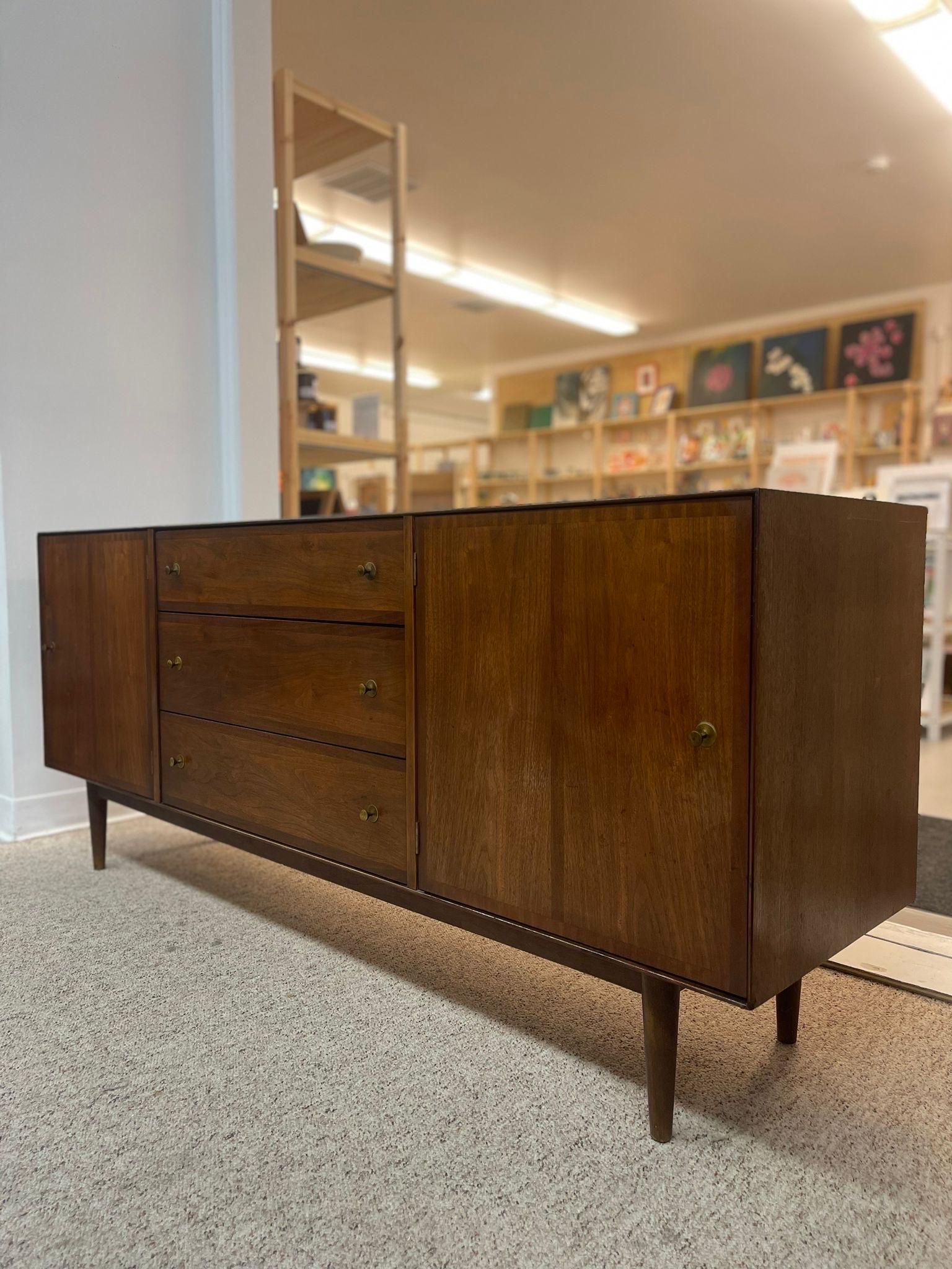 The Subtle Details of this Dresser Make it Incredibly Unique.Three Drawers, the Tipt Drawer Includes Dividers.Mid Century Modern Style with Tapered Legs and Dark Toned Wood.Makers Mark Inside Cabinet as Pictured. Dovetail Drawers.

Dimensions  70 W