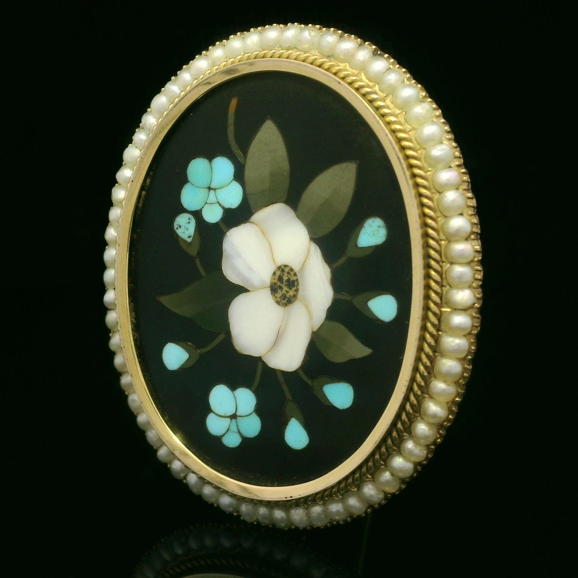 -- Stone(s):--
(1) Black Stone - Oval Cut - Bezel Set - Black Base w/ Inlaid Floral Work Green White & Blue Colors-Natural Stones- 35.6x28mm (approx.)
Numerous Genuine Cultured Pearl - Round Shape - Wire Set - White Color

Material: Solid 14k Yellow