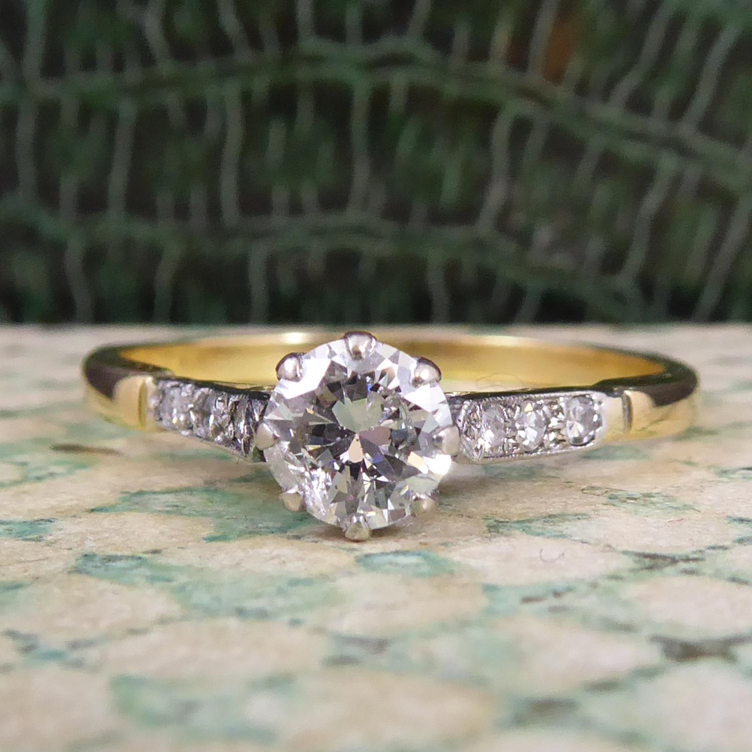 A neat and petite vintage diamond ring from the mid-20th century era.  Featuring a single diamond approx. 0.54ct held in a white rex coronet setting.  To either side of the main diaond are three 8-cut diamonds to white-fronted and pointed shoulders.