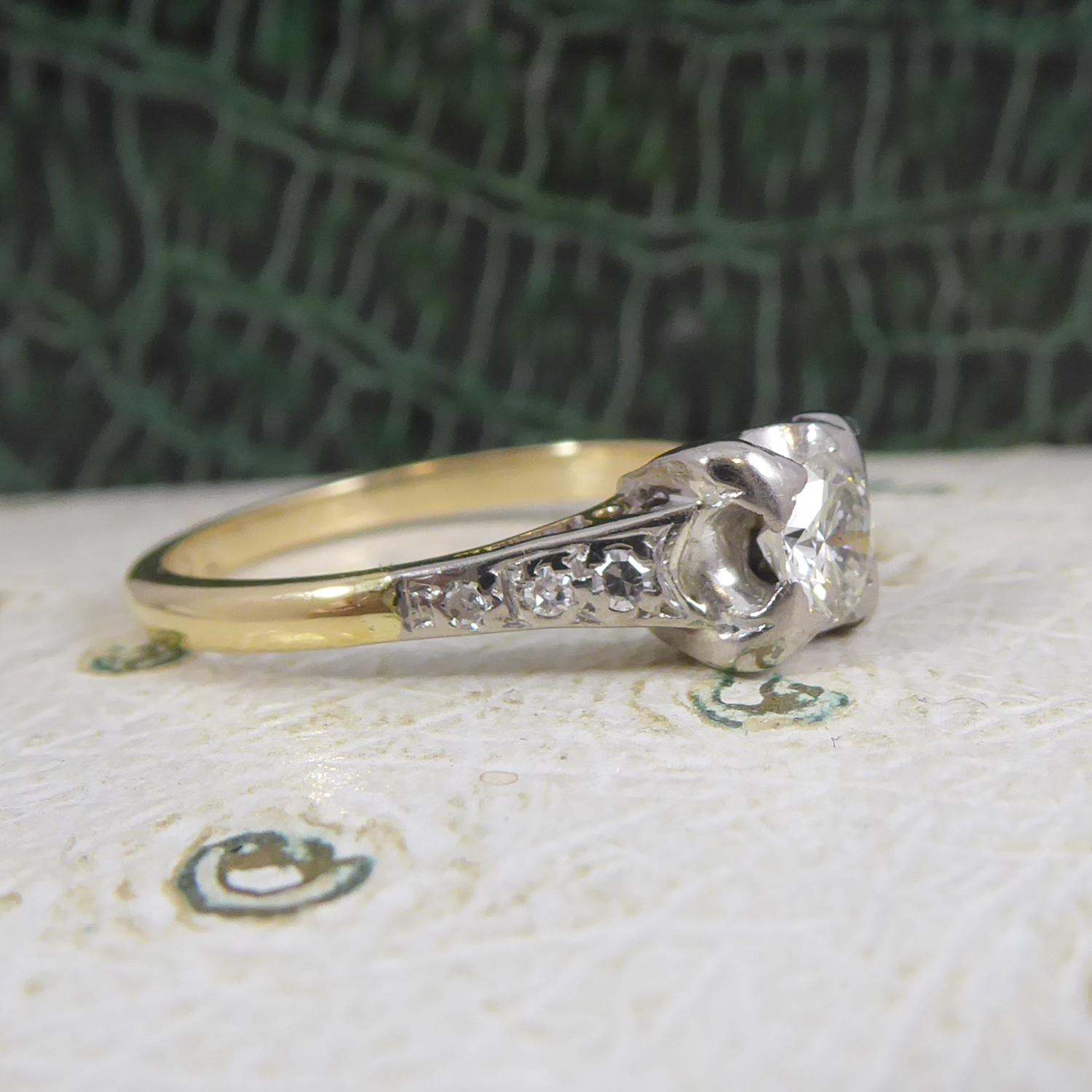 A very pretty solitaire diamond ring, approx. 0.25ct and four claw set to a white square box mount.  The shoulders are platinum topped and each is set with three diamonds.  Yellow gold D shaped, cross sectioned band.  Not hallmarked, tests as