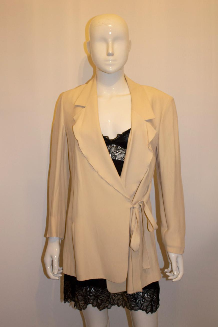 A chic vintage jacket from Sonia Rykiel , mainline. The jacket has an interesting design with a double collar , tie at the side and small and large button detail on the cuff, plus vertical pockets on the front. It is unlined. Size 40 , made in