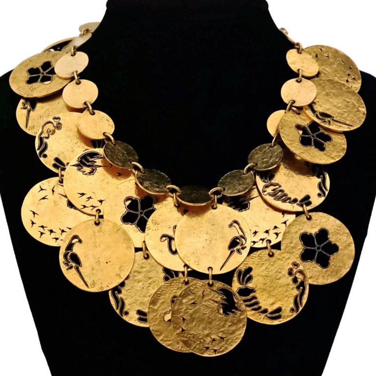 Vintage SONIA RYKIEL Openwork Disc Bib Necklace

Measurements:
Height: 3 3/8 inches
Wearable Length: 15 inches to 16 inches

Features:
- 100% Authentic SONIA RYKIEL.
- Multi later discs with open work Flowers, Birds and SR logo pattern.
- Opulent