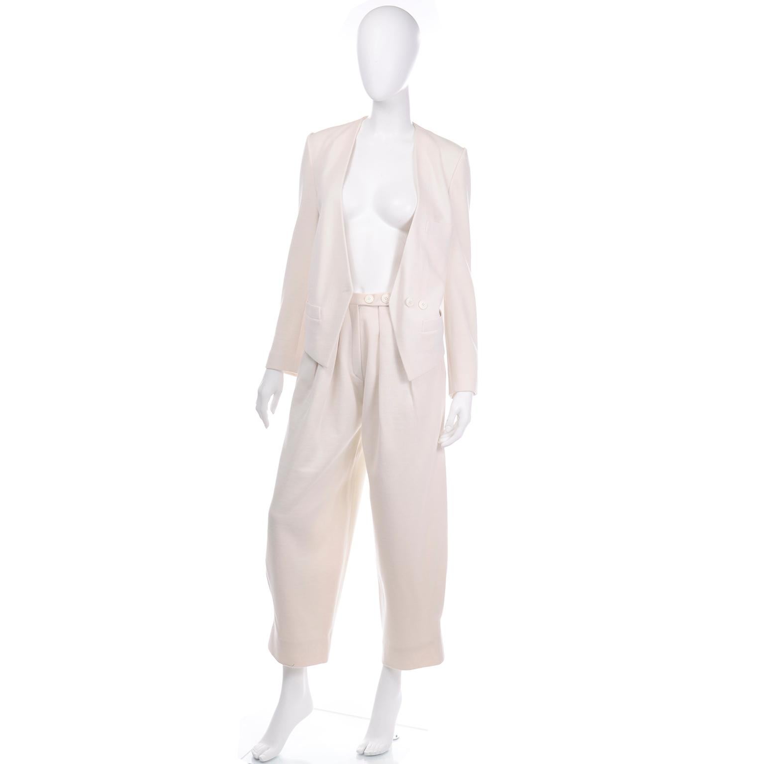 This is an absolutely incredible creamy ivory summer wool balloon pantsuit outfit. The jacket is an abstract blazer style with a double button closure, two side pockets and a small breast pocket. We love the pointed edge hem with a unique cut out in