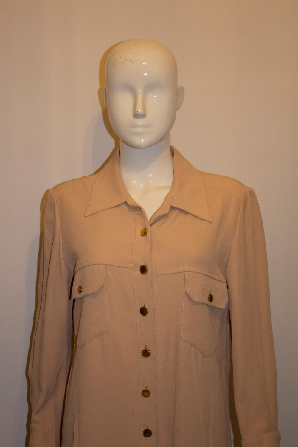 A chic vintage shirtdress by Sonia Rykiel, mainline. In a pale caramel colour, the dress has 2 breast pockets, 2 faux pockets lower down and a 10'' slit on either side. . It is unlined. 
EU size 40 measurements; Bust up to 39'', length 43''