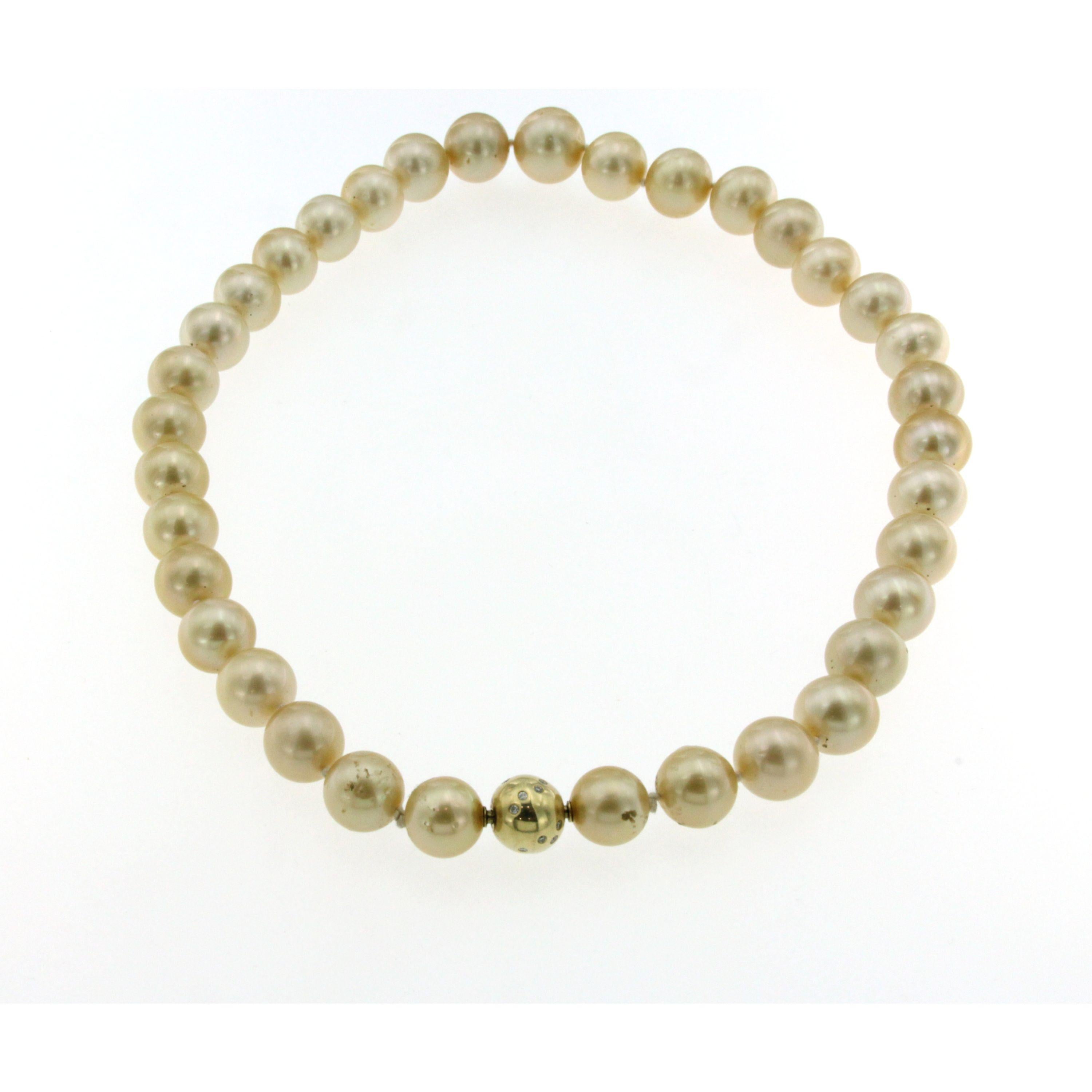 Beautiful large Golden South Sea pearl necklace, this strand includes 12-14 millimeter pearls strung on a knotted silk thread and fasten with a gorgeous 18k yellow gold diamond clasp. This strand is an heirloom quality piece that will be enjoyed for