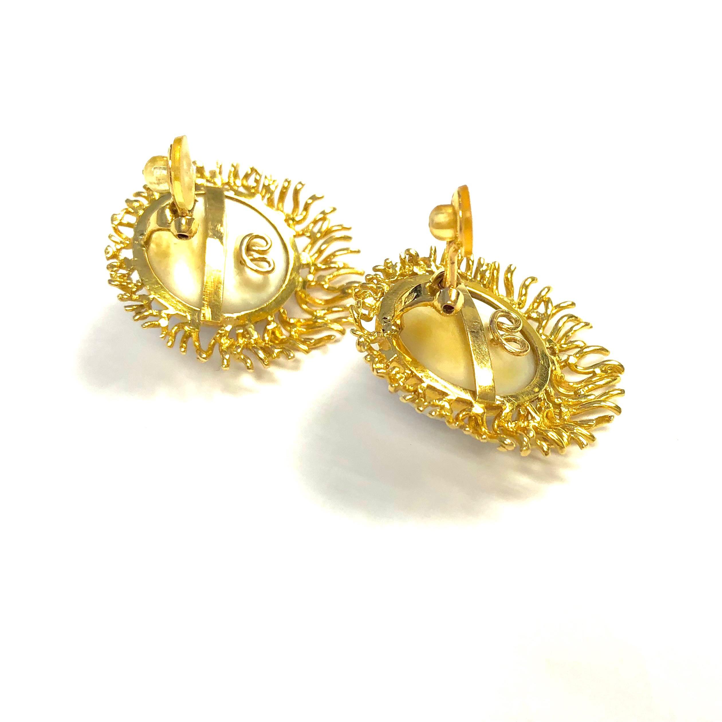 Crafted in 18K yellow gold, the earrings feature white South Sea mabe pearls in the center, measuring 20 mm in diameter. 
Each earring measures: 1 1/2
