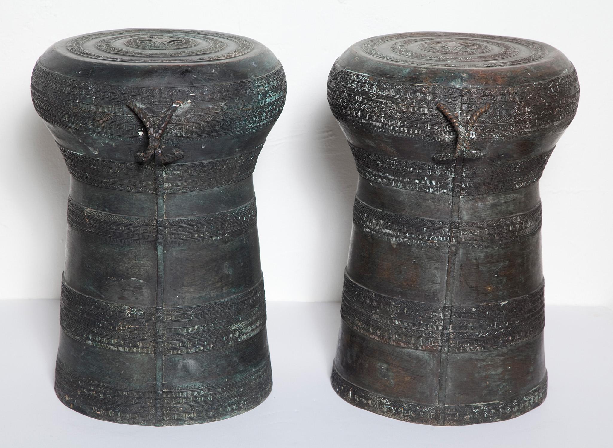 Vintage Southeast Asian cast bronze rain drums have traditional center star motif and geometric patterning with braided side handles. Natural patina varies from dark brown to verdigris to black. Sold individually, the list price below is for a