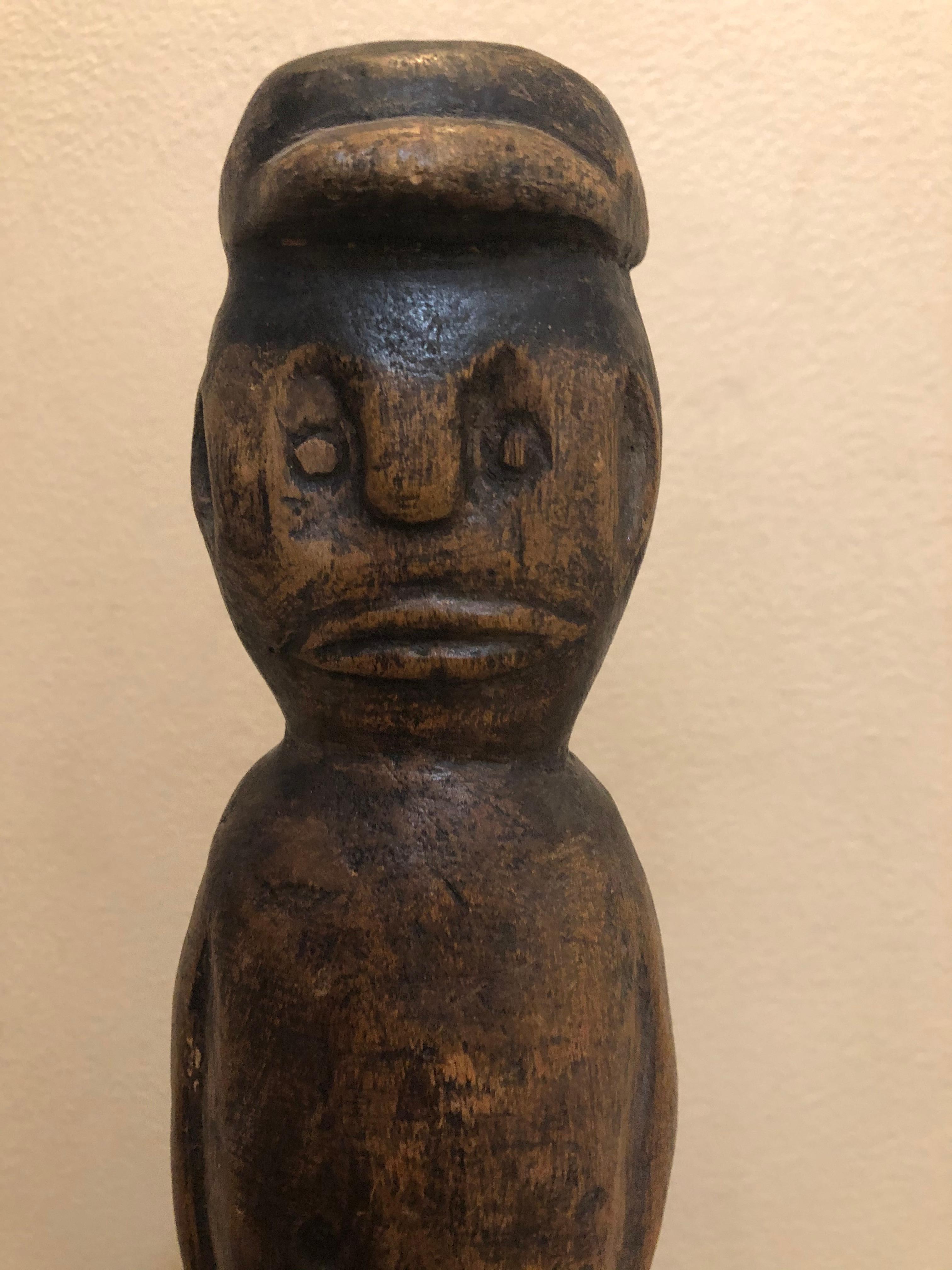 Very kool piece of folk art. I am not exactly sure how old, but from bottom of base I would guess 1st quarter of 20th century. It is all wood and depicts what I believe is a black man with a cap or baseball cap. Very well carved.