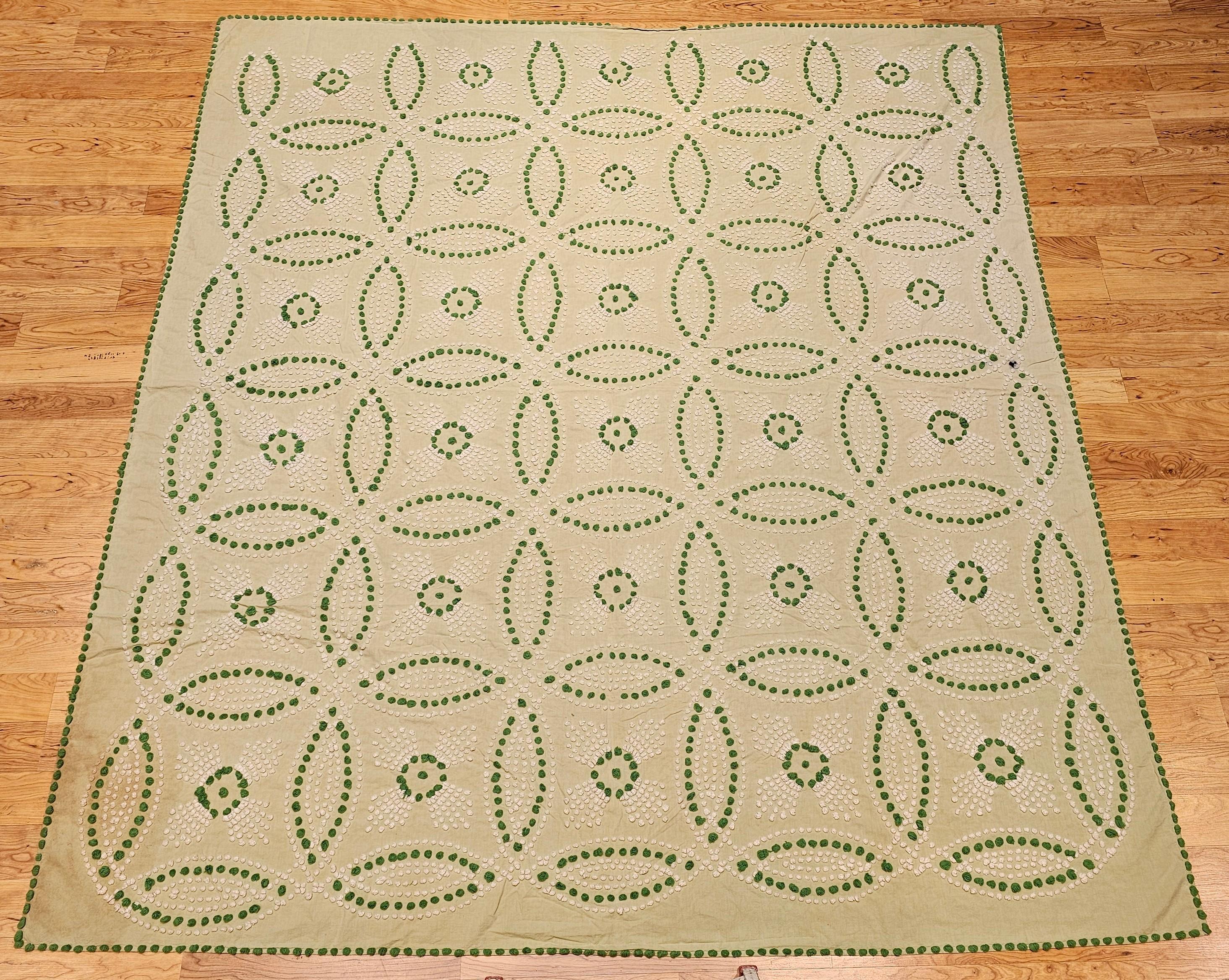  Early 20th century hand-stitched southern quilt top from SE United States most likely North Carolina.  It has a “Double Wedding Ring” quilt pattern set on  a lime green background with the ring designs in hand embroidered ivory and green colors