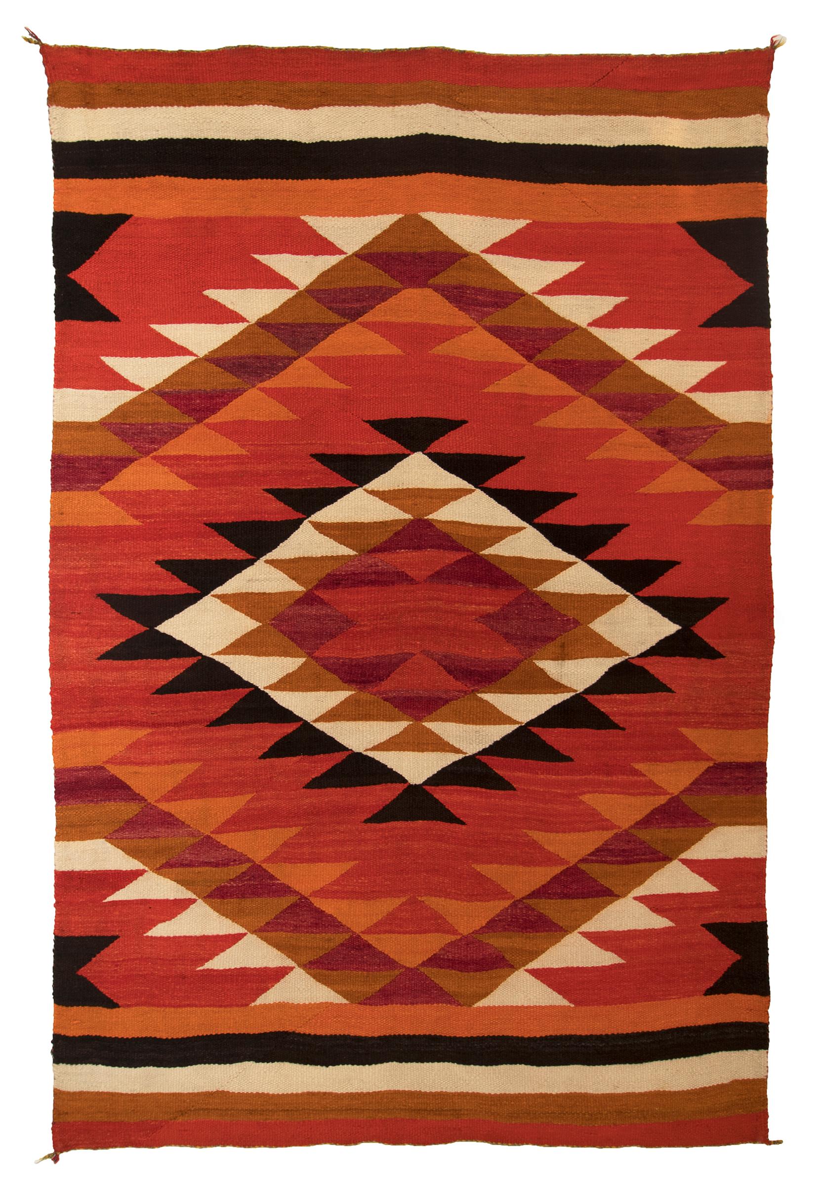 Vintage 19th century (circa 1880) Late Classic/Transitional period Navajo textile in a wearing blanket format. Woven of native hand-spun wool in a diamond and banded pattern with aniline red, orange maroon/purple and brown with natural fleece colors