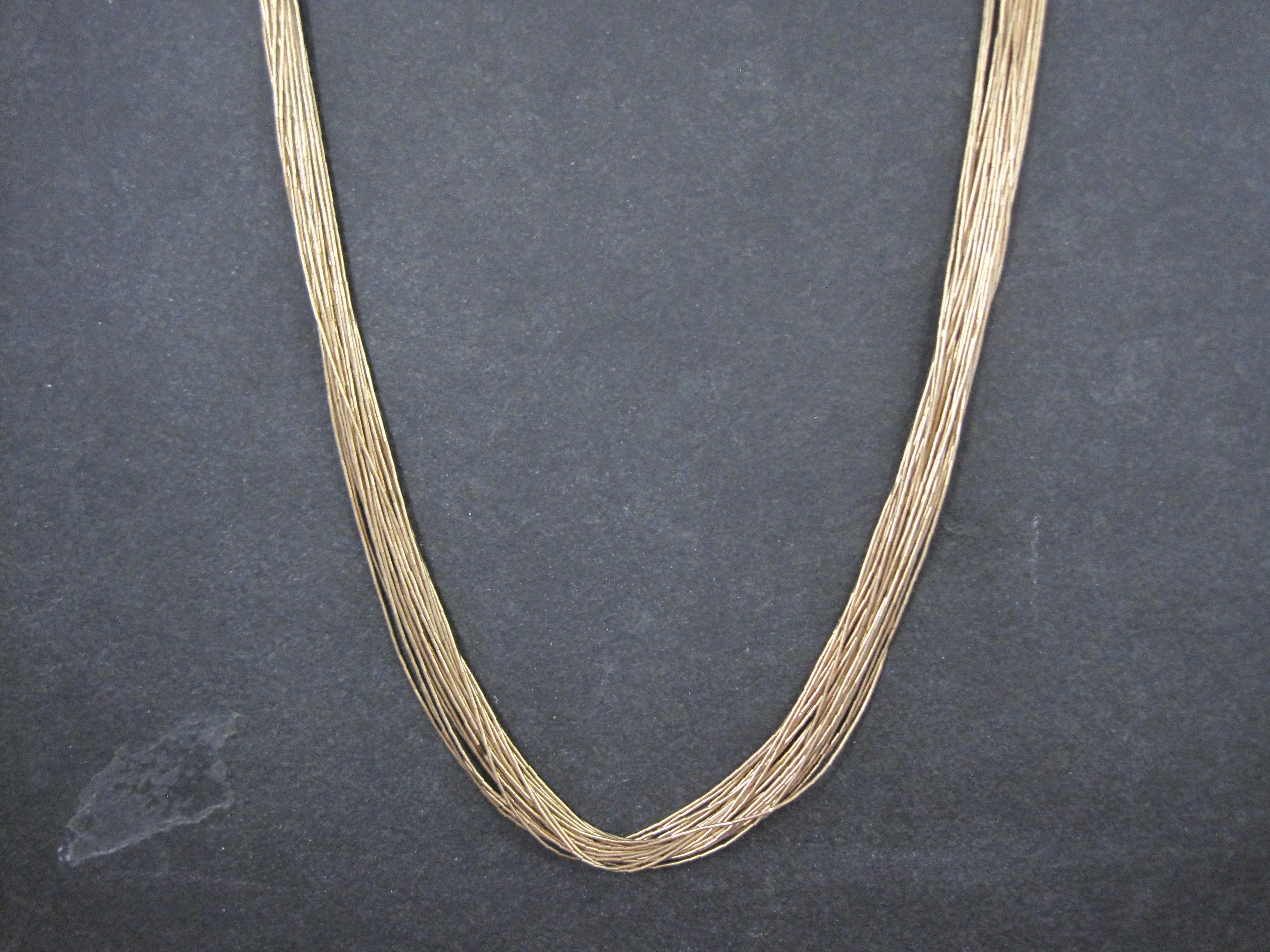 
This stunning Southwestern heishi necklace showcases 30 strands of shimmering gold-filled liquid gold beads. Designed with elegant movement and rich shine, the necklace measures 30 inches in wearable length, making it a bold yet versatile statement