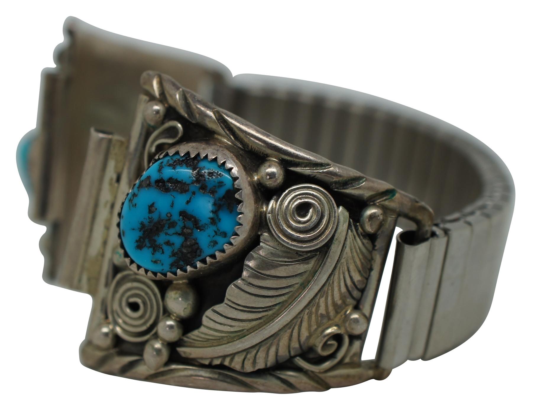 Vintage sterling silver 925 and polished turquoise stone watch band featuring a southwest design of beads, spiral and feathers around the stones and a lightly patterned flexible metal Expansion band; marked AY Sterling.

Measures: 6.5” x 1.25”
