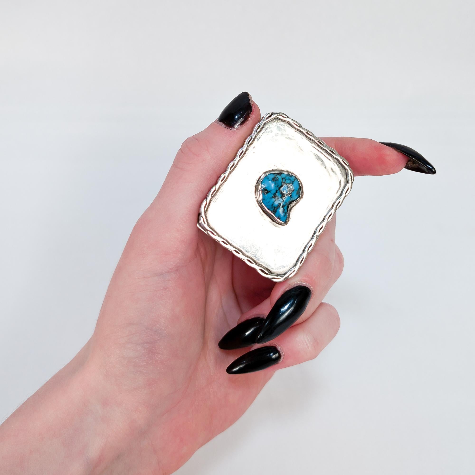 A fine, small scale Southwestern covered box.

In the Navajo style.

In solid silver (likely sterling).

Bezel set with a turquoise cabochon to the lid.

Marked with a maker's mark JM to the underside.

Simply wonderful Southwestern silver!

Date: