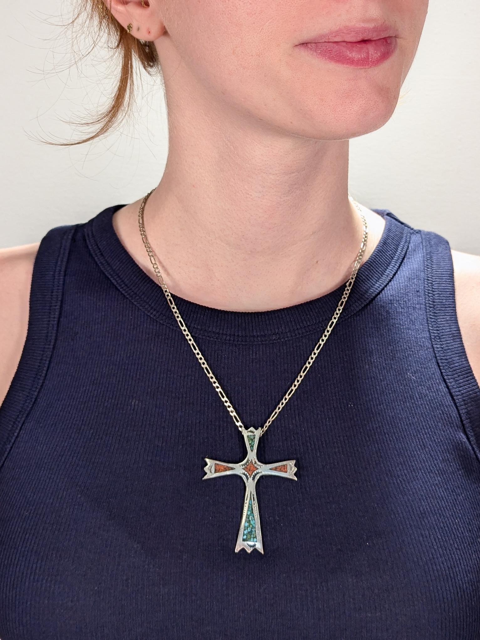 A fine Southwestern pendant cross. 

In silver.

With chip turquoise and coral inlay and hammered decoration throughout.

With a fixed bail to the reverse.

Simply a wonderful Southwestern cross!

(Chain for display purposes and not included with