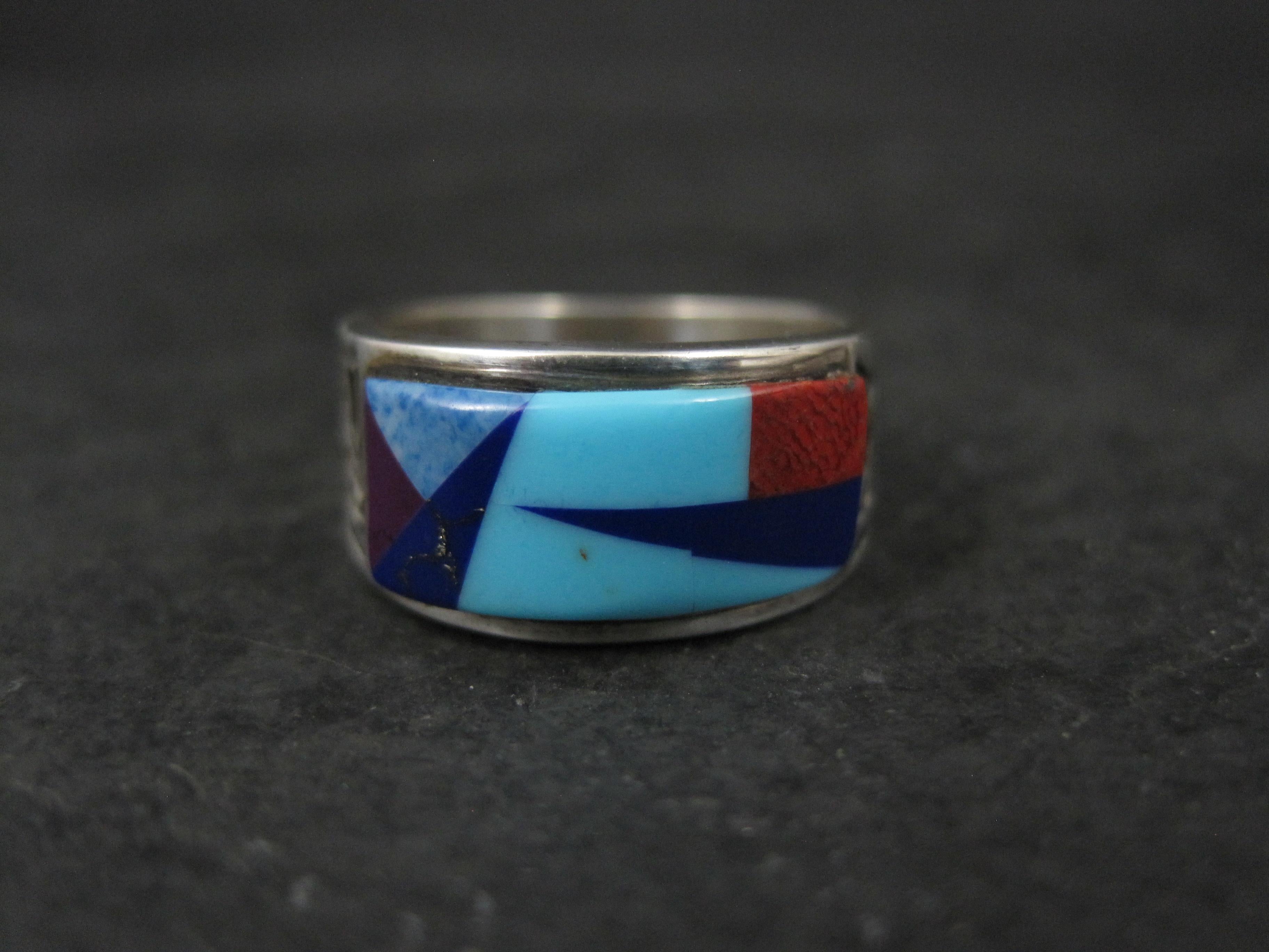 This gorgeous Southwestern ring is sterling silver with sugilite, lapis lazuli, denim lapis, turquoise and coral inlay.

Measurements: 9mm wide
Size: 5.5

Marks: M, Sterling

Condition: Excellent
