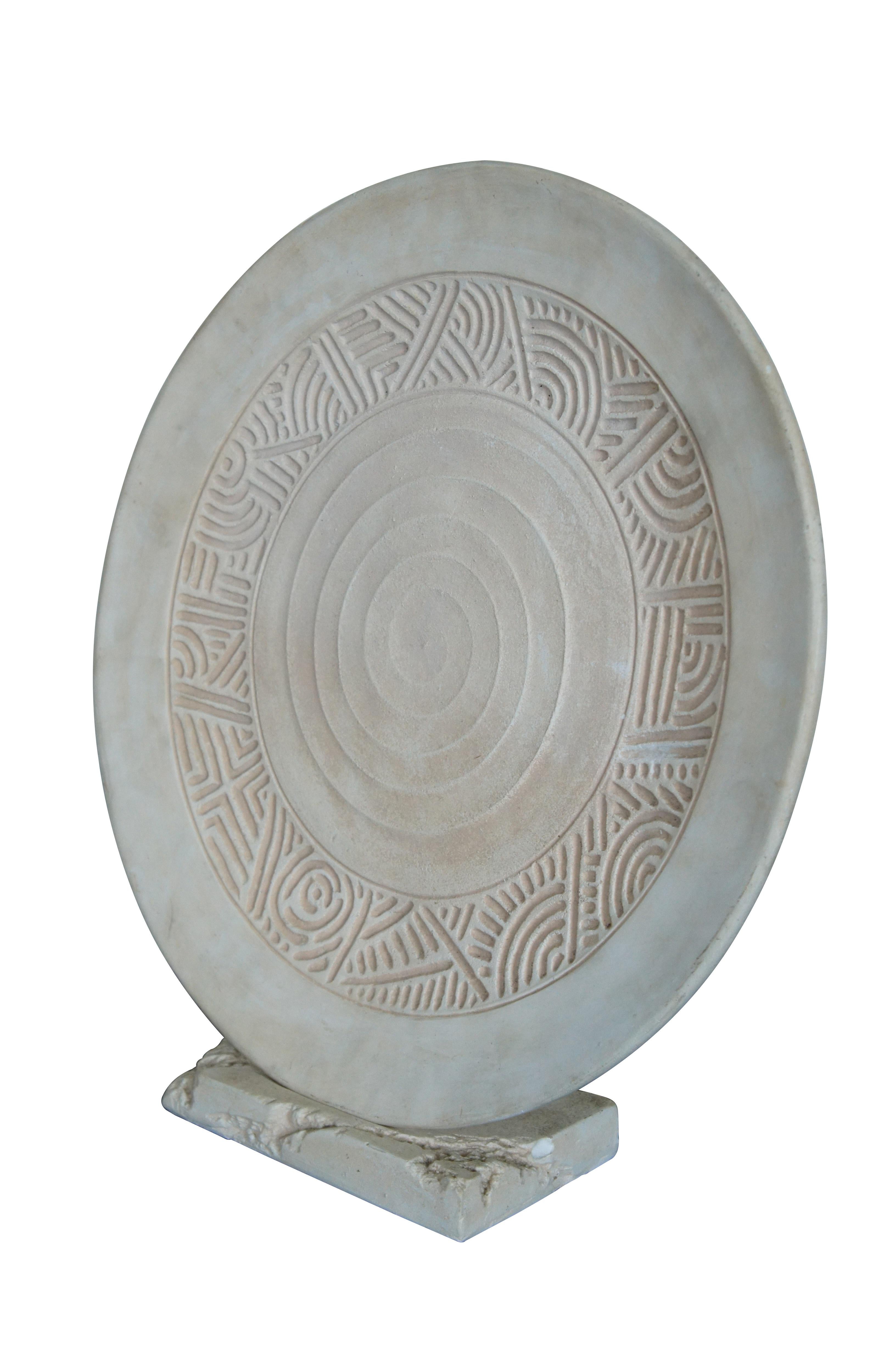 Vintage chalkware art sculpture display featuring a plate / charger / round disk with geometric patterns.  Includes base / stand.


Dimensions:
22.25” x 6” x 23.25” (Width x Depth x Height)