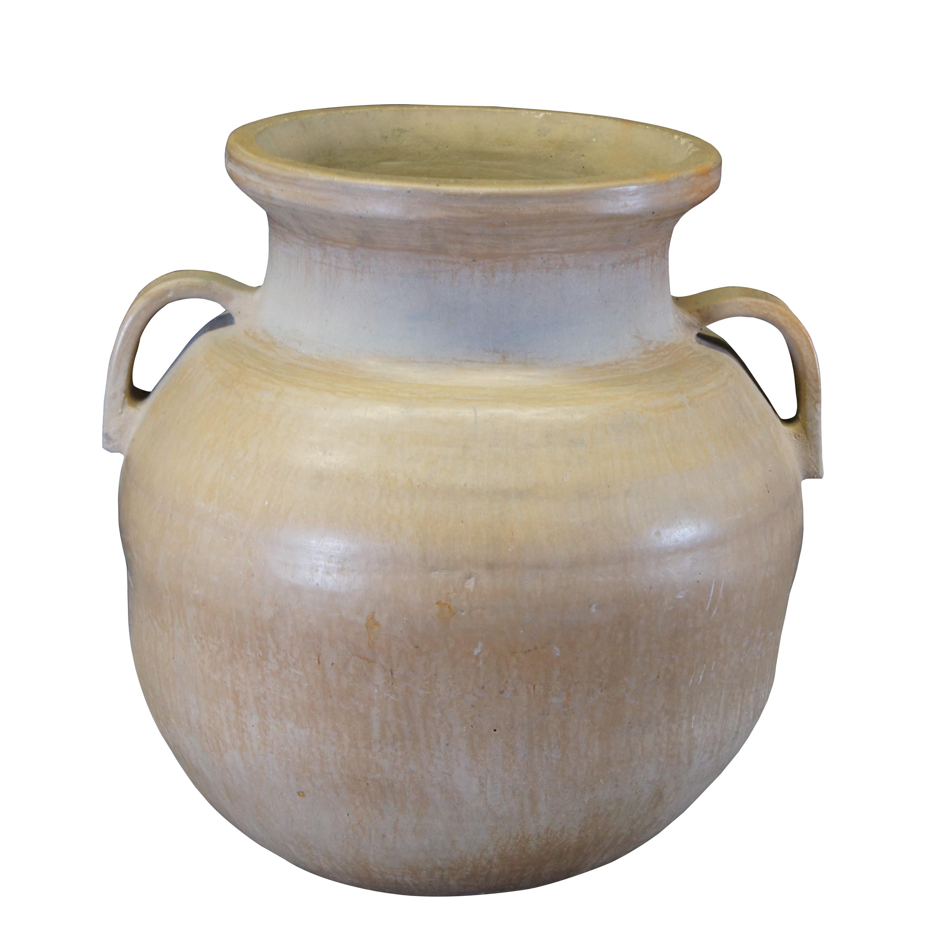 A very large vintage Earthenware planter / jardiniere / flower pot / cachepot or urn.  Made of terra cotta featuring Southwestern / Tuscan design with large open top, two handles, and bulbous form.

Dimensions:
27