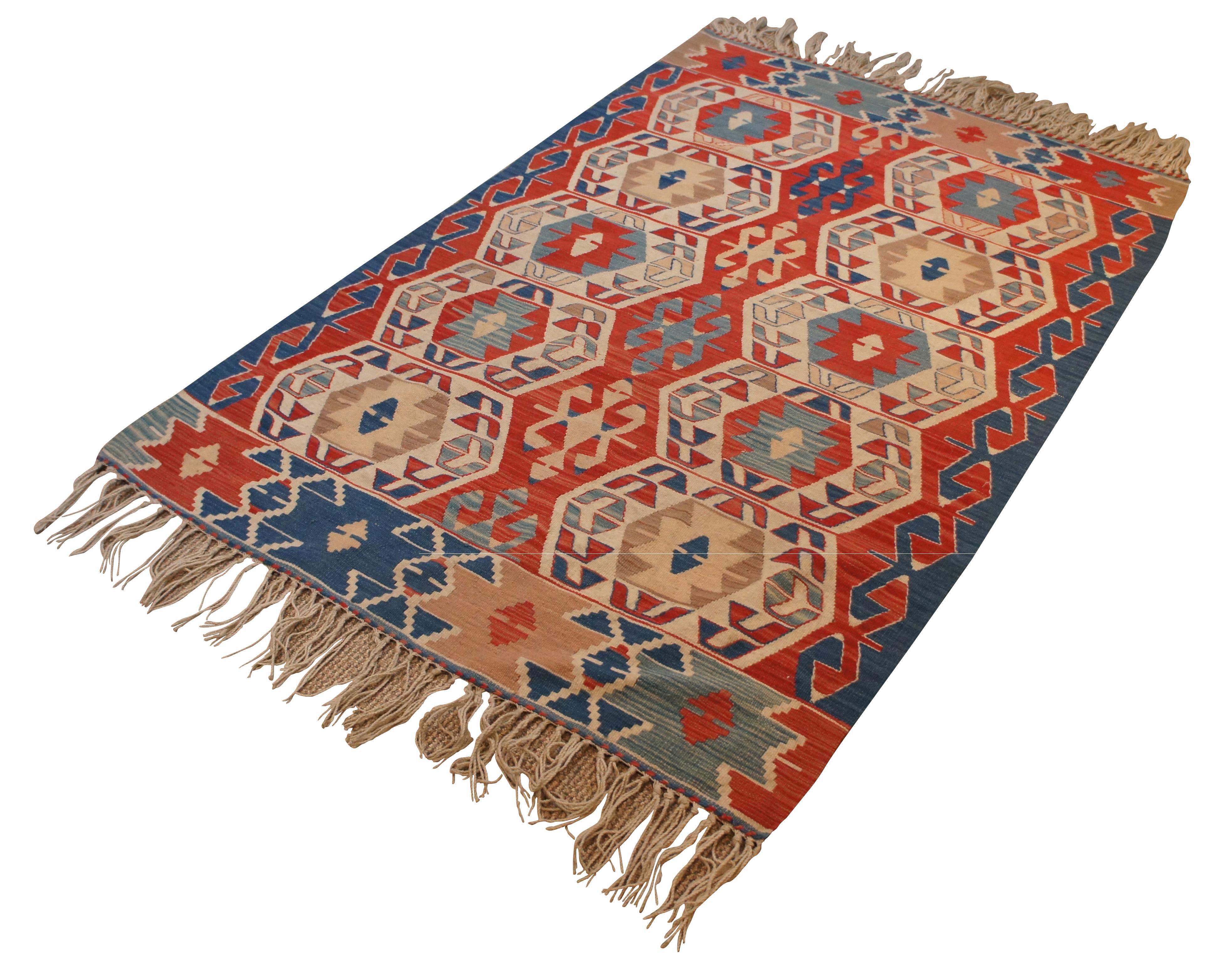 Vintage red, blue and beige geometric Turkish kilim rug with fringe. Approx 3' x 5'.

Measures: 64” x 43.5” / 5.3’ x 3.6’ / Fringe Adds – 5” (Length x Width).