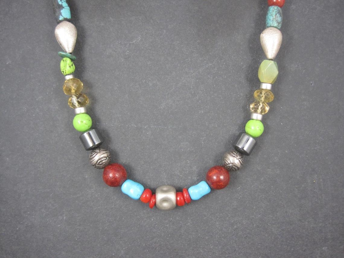 This gorgeous southwestern necklace features natural turquoise, coral, hematite, lapis lazuli and gaspeite beads, faceted crystal beads and handmade sterling beads.
The silver beads, end caps and clasp are all sterling silver.

At its widest, this