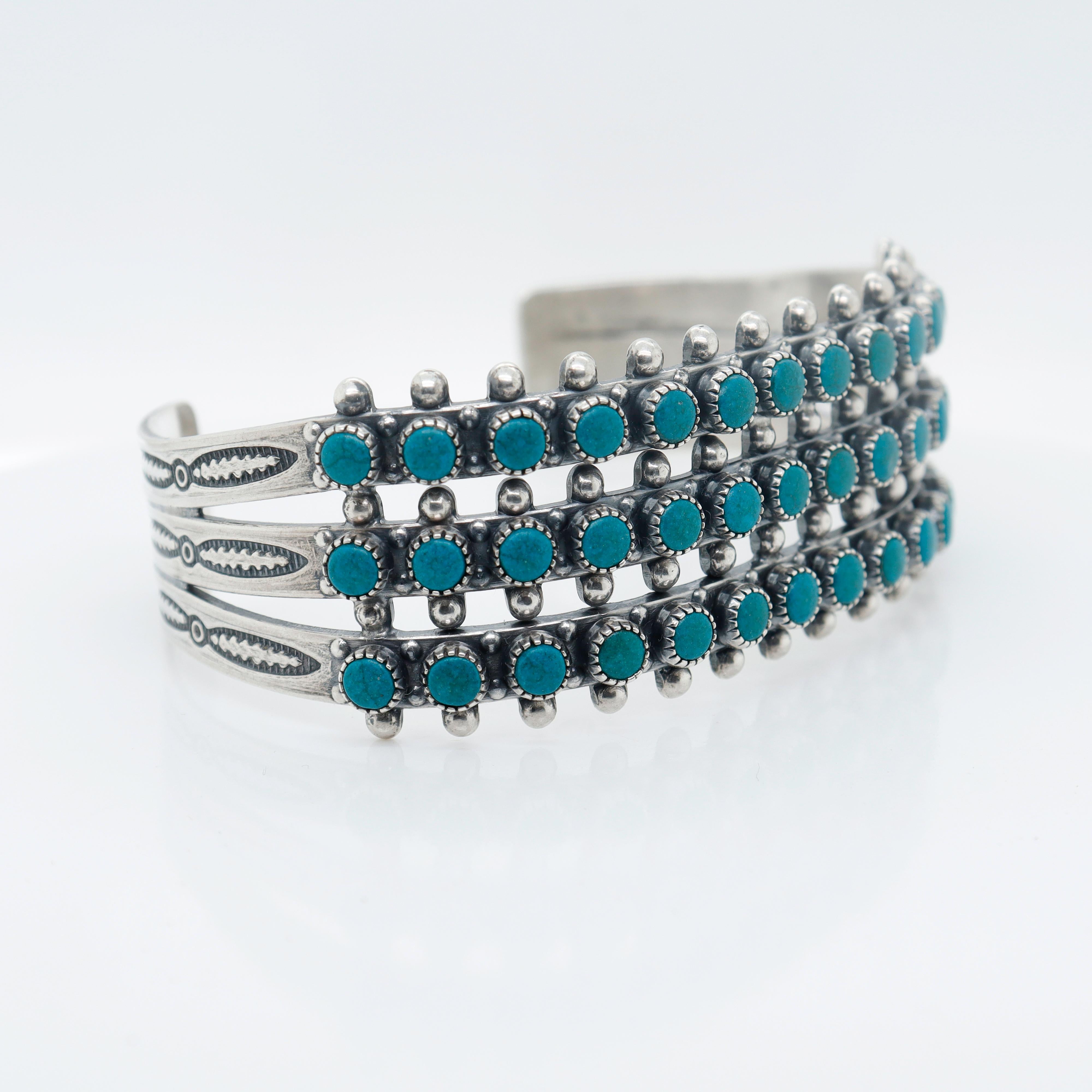 A fine turquoise Zuni Pueblo cuff bracelet.

In sterling silver.

Bezel set with 3 row of small turquoise cabochons.

Simply a wonderful Southwestern bracelet!

 Date:
20th Century

Overall Condition:
It is in overall good, as-pictured, used estate