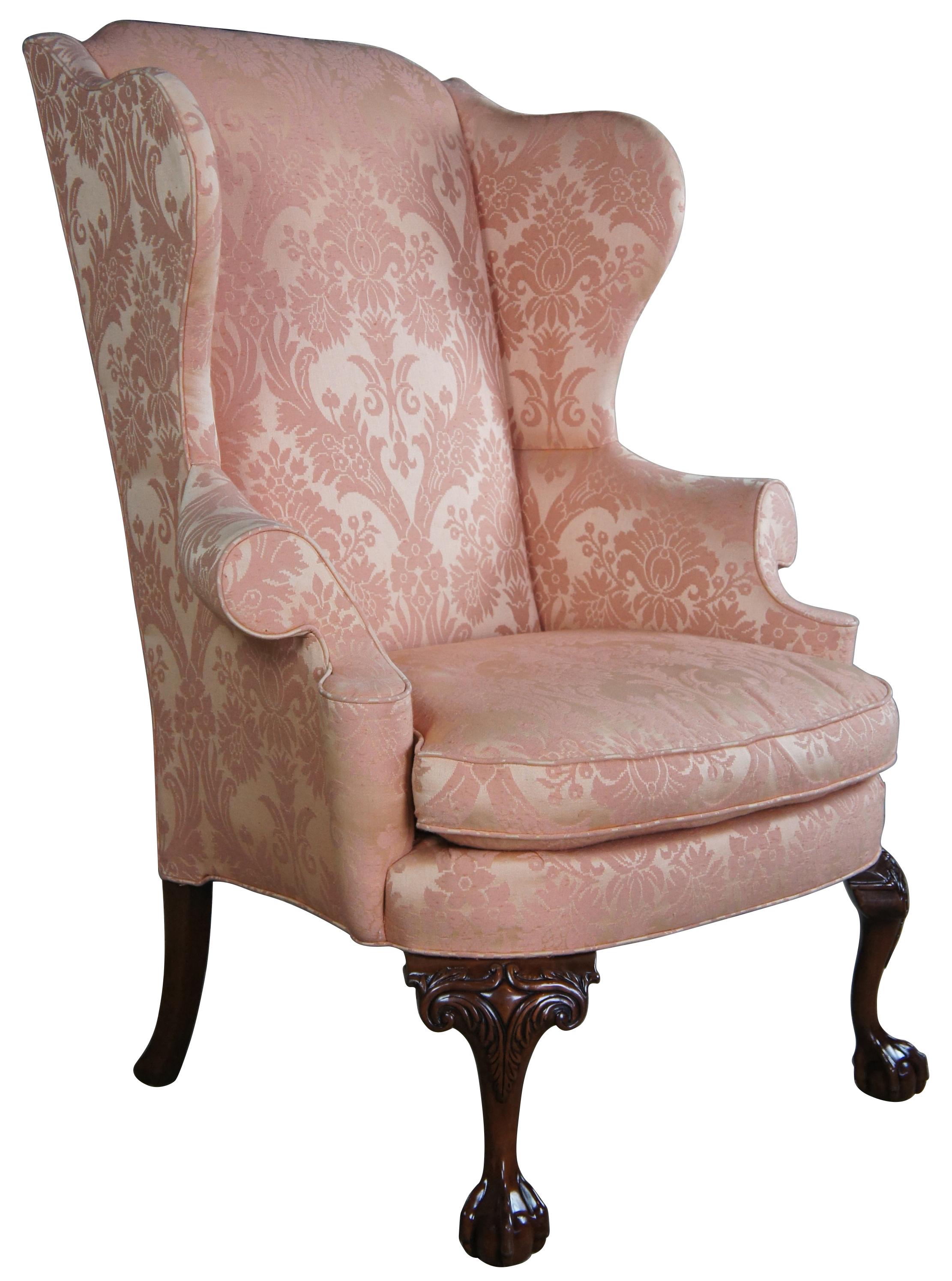 Southwood (Hickory, North Carolina) wing back chair. Made from mahogany frame with carved front Ball & Claw feet and square splayed legs at the back. Upholstered in a pink damask fabric.
   