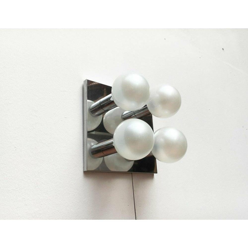Imposing mid century ceiling or wall light from Staff according to a design by the Japanese designer Motoko Ishii.

This design convinces with its reflective surfaces. The game with reflections creates a special depth. The reflective areas double