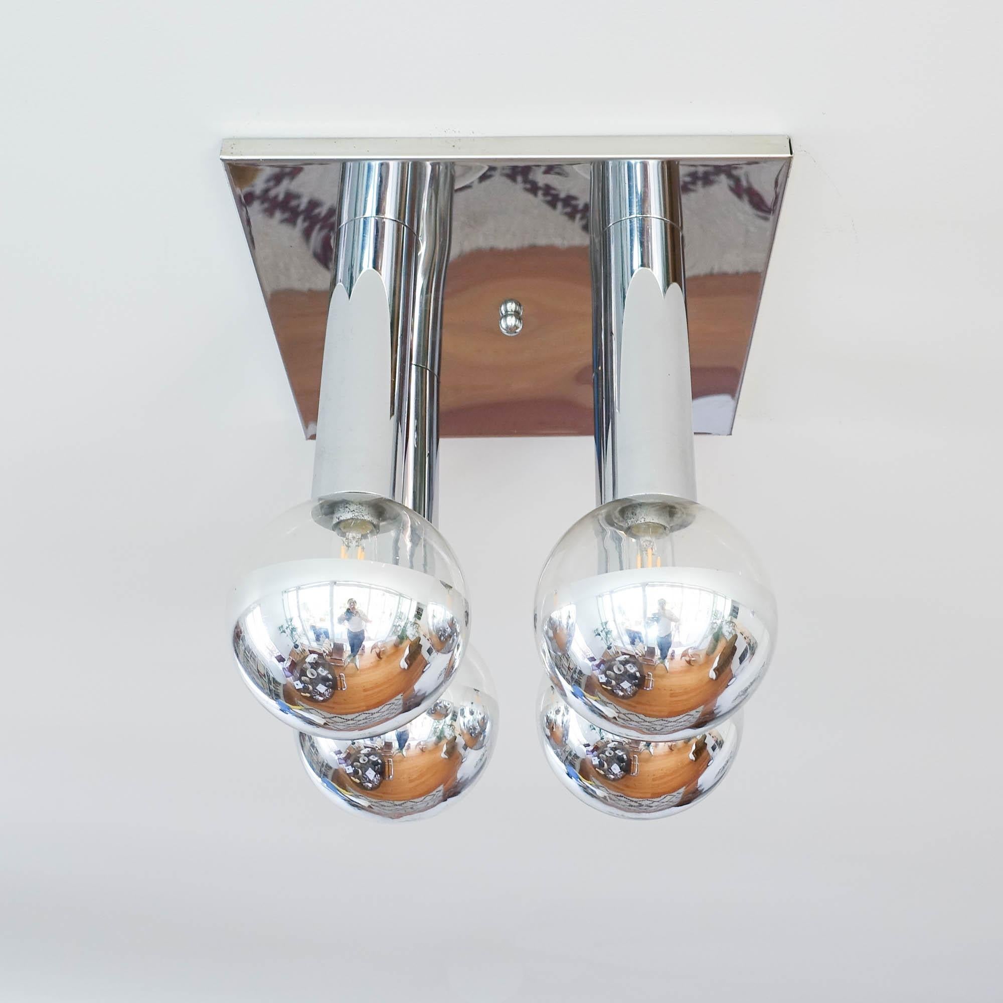 This ceiling lamp was designed by Motoko Ishii for Staff, in Germany, during the 1970's.
This design impresses with It's mirrored surfaces. Playing with reflections creates a special depth. The reflective surfaces double the elements and enhance