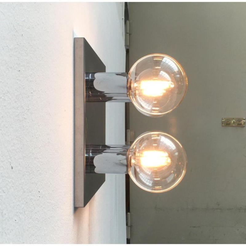 Imposing mid-century ceiling or wall lamp made by staff to a design by japanese designer motoko ishii.

this design impresses with it's mirrored surfaces. Playing with reflections creates a special depth. The reflective surfaces double the elements