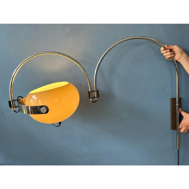 Oft-sought after vintage double arc space age wall lamp by Dijkstra with mushroom shade. The mocca-coloured mushroom shade produces a warm, cosy light. The inner arc can be positioned aligned with or opposed to the main arc. The lamp requires an E27