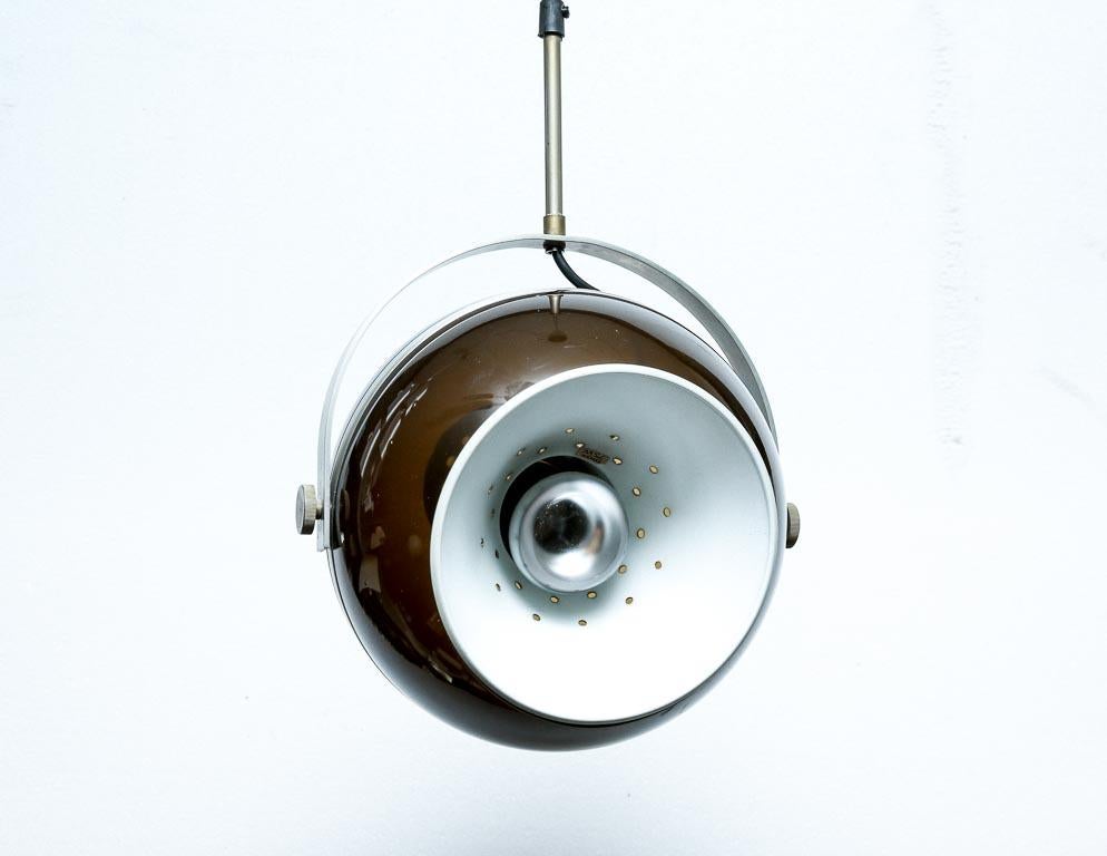 Vintage 'eyeball' pendant lamp by Dijkstra, Holland. Translucent tobacco-brown casing with chrome accents and angle-adjustment hardware. Includes original ceiling CAP.

This lamp is currently set up for hard-wiring. We offer a service to add