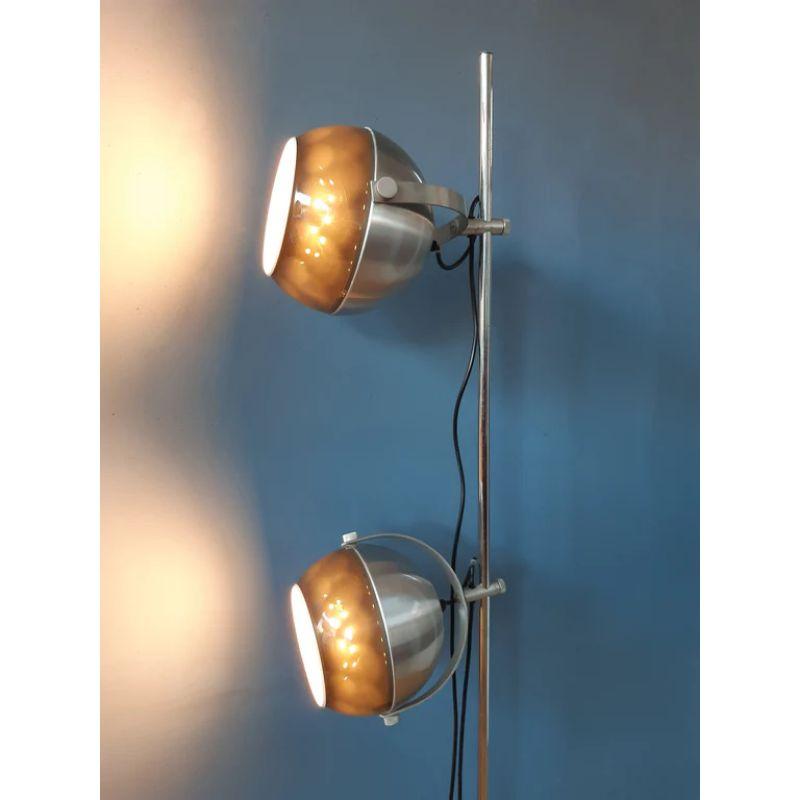 A very rare space age floorlamp by Dijkstra Holland. The shades are constructed form brown/copper coloured acryllic and metal. They can be directed in any way and moved up and down the tripod. The lamp requires two E27 bulbs and currently has an