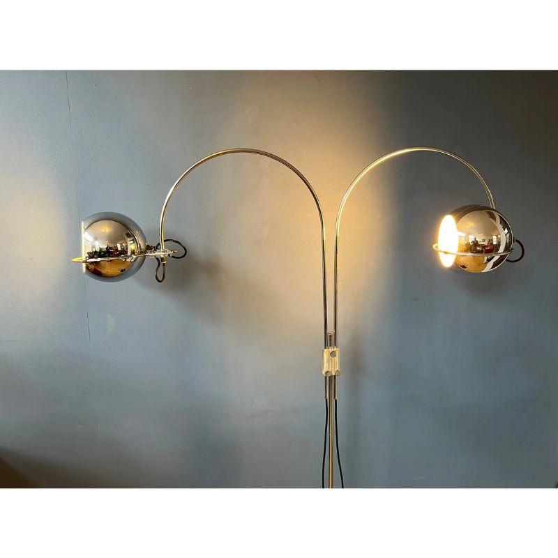 Very rare double arc eyeball floorlamp by GEPO in chrome. The arcs can be adjusted in height and turned all around. The eyeball shades can be positioned inside or outside the arcs and placed in the rings in any direction desirable. The lamp requires