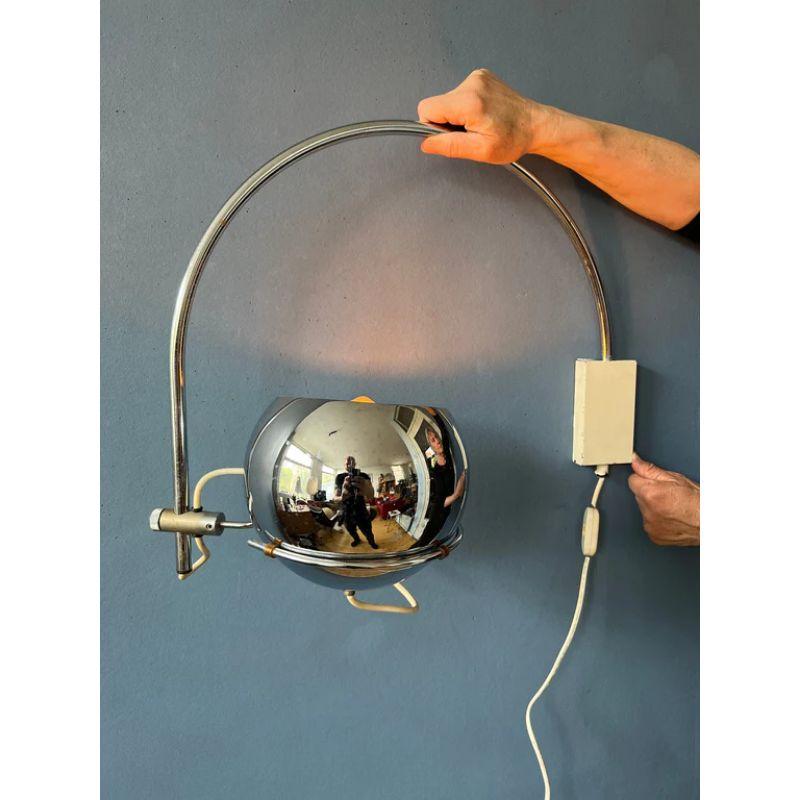 A classic arc wall lamp with eyeball shade from the Dutch brand GEPO. The shade can be placed in any direction desirable and positioned inside or outside the arc. The lamp has a switch build into the cable. The lamp requires an E27 (standard)