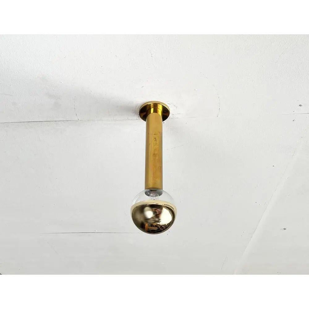 Imposing mid century ceiling or wall light from staff according to a design by the japanese designer motoko ishii. Here in a rare version in brass with gold -colored mirrored ball.

This lamp can be mounted on the ceiling or wall. Individually, as a