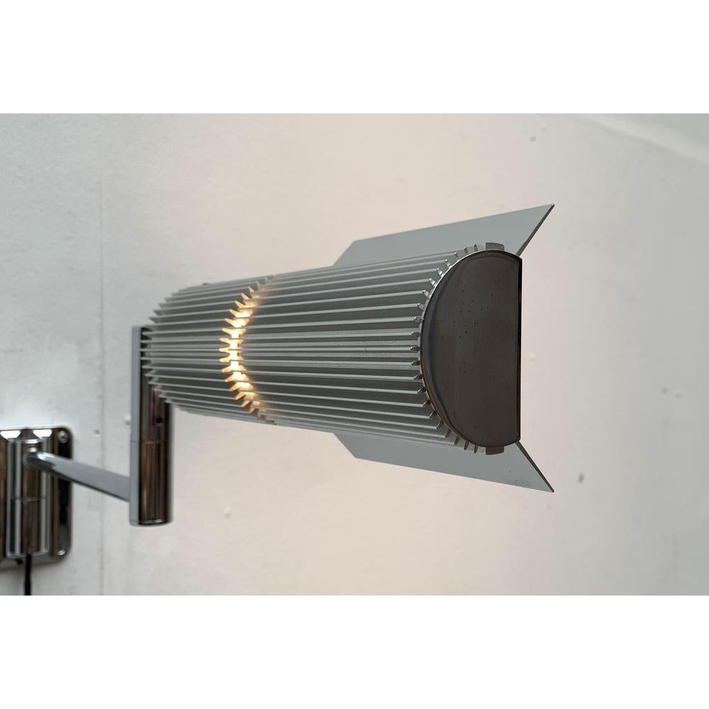 Rare halo profile wall lamp from Swisslamps.

The design dates from the 1970s. This wall lamp draws its elegance from a technical design language. This is supported by the design in aluminum. The precision in processing and the high-quality