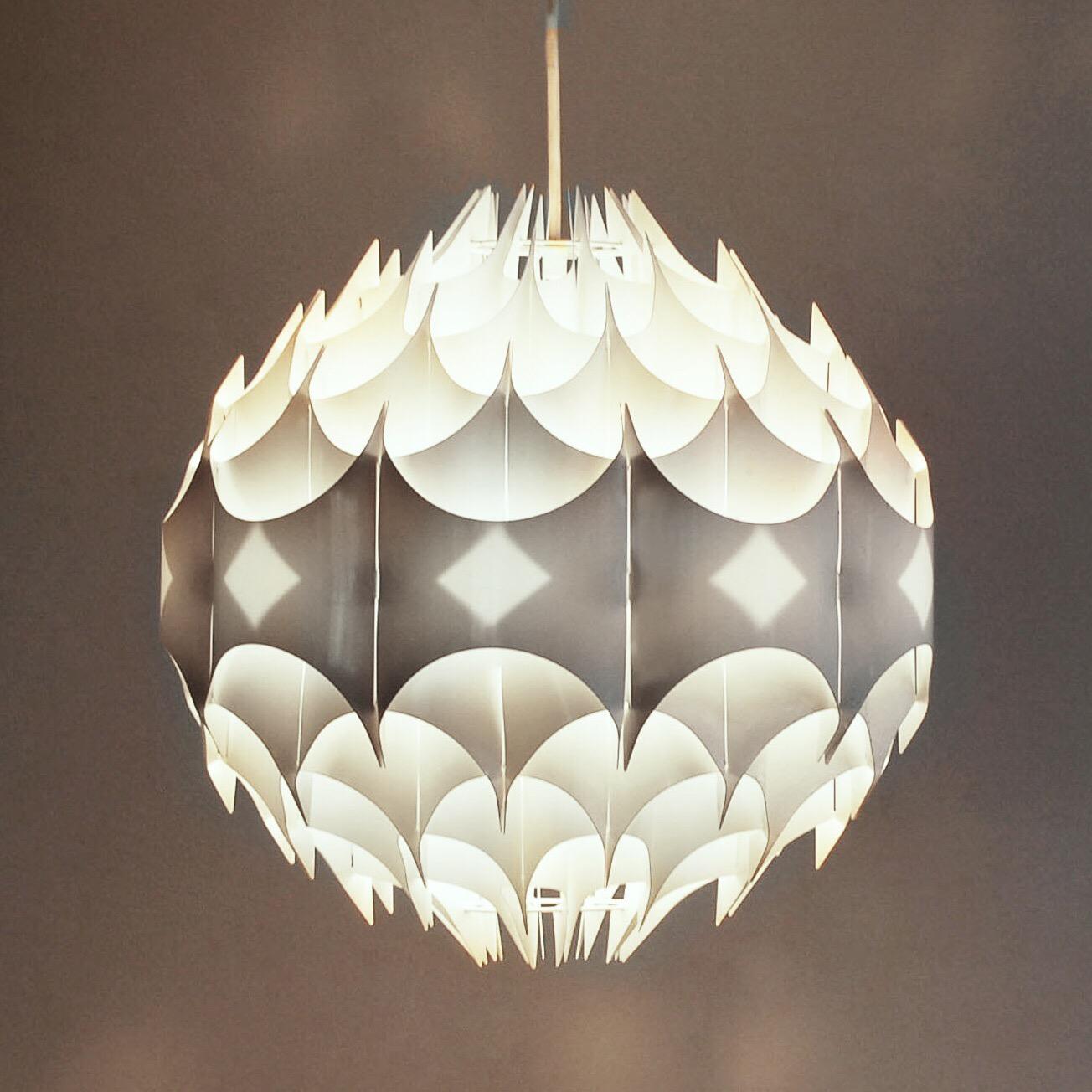 A hanging globe pendant, designed by Havlova Milanda and entitled 'Rhythmic' for Vest of Austria, produced circa 1960s-1970s, composed of folded sheets of flexible, creamy white plastic, creating a hyper-modern, very fresh and contemporary