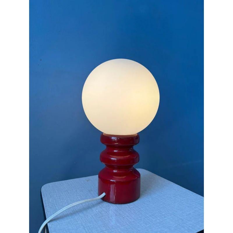 A rare German glass-made table lamp in the style of Carlo Nason. The lamp has a red ceramic base. The lamp requires one E27 lightbulb and currently has an EU-plug.

Dimensions:
ø Shades: 16 cm
Height: 25 cm

Condition: Excellent. The ceramic