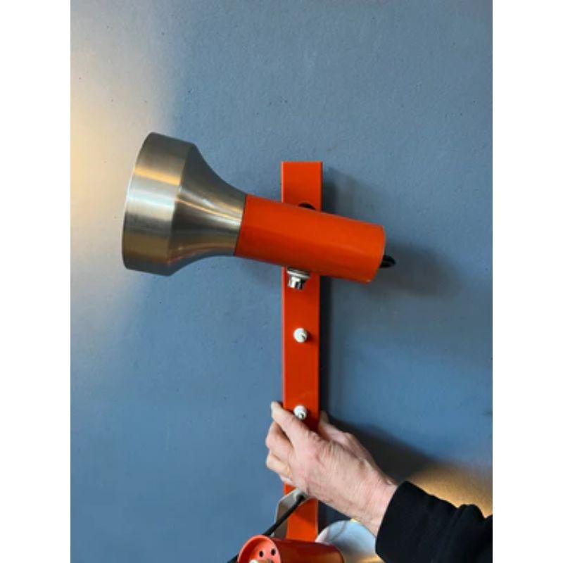 A classic space age wall lamp in orange/red colour. The design allows you to position the sconces in any way desirable. The lamp requires two E27 lightbulbs and currently has an EU-plug.

Dimensions:
Height: 35 cm
Width (max): 16