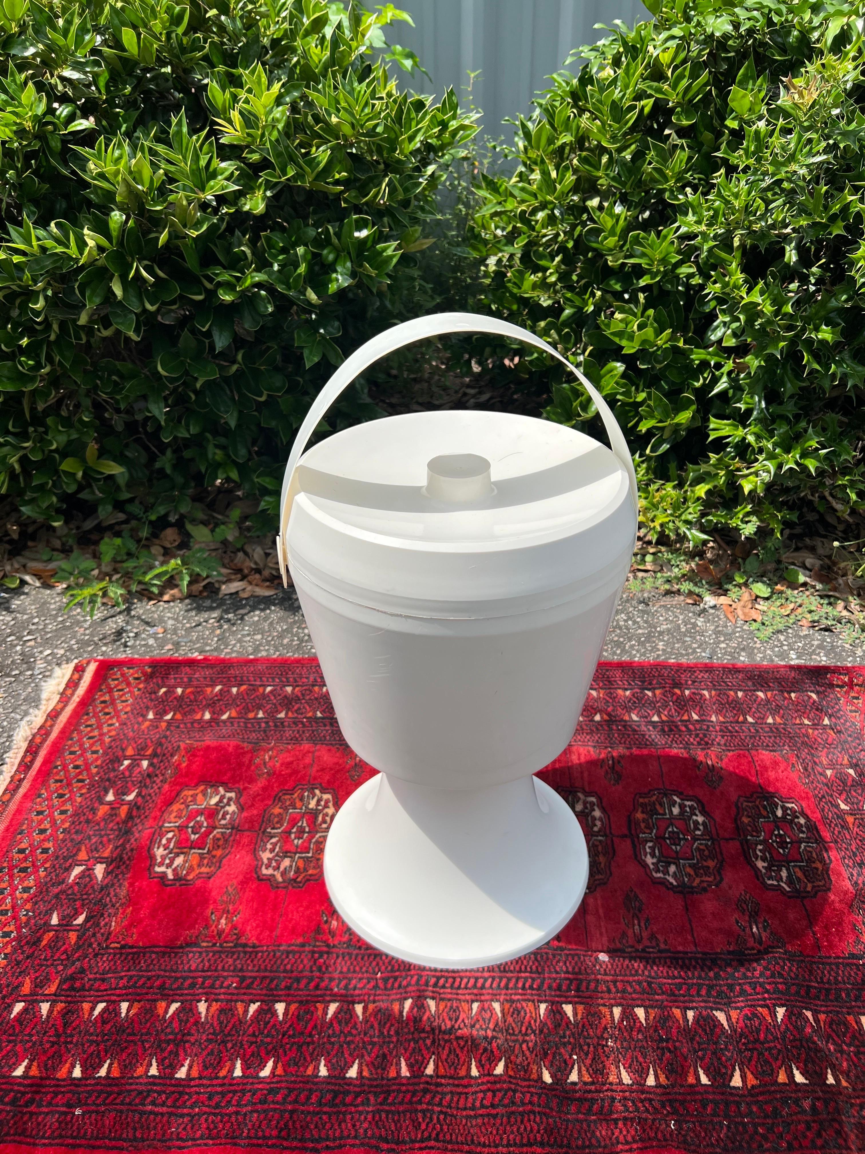 Super cool extra large space age white ice bucket. Would look equally as amazing as a planter. Has an insert that you can easily remove if desired. 
21.5” with handle