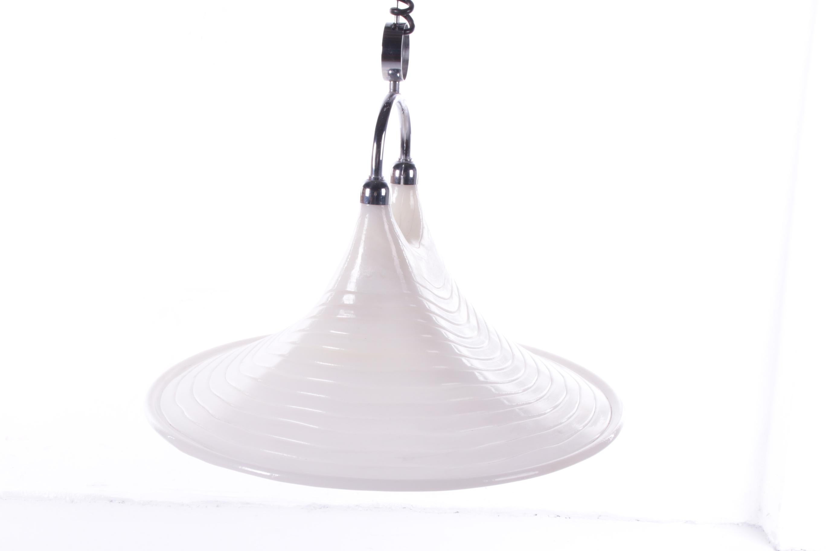 This is a beautiful white Spice Age plastic with Chrome hanging lamp.
Is Made By Cristallux Germany 1970
There is a spring in it to hang the lamp down or up.
There are kind of lines in the hood, which gives a nice effect when the lamp is on.
It
