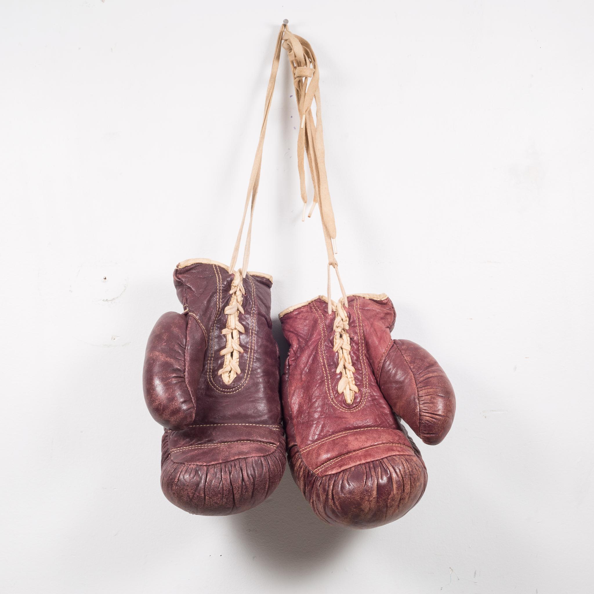 About

A pair of authentic vintage boxing gloves with reddish, brown leather. Each glove has tan leather piping and laces. The leather is very soft and is good condition. Stamped 