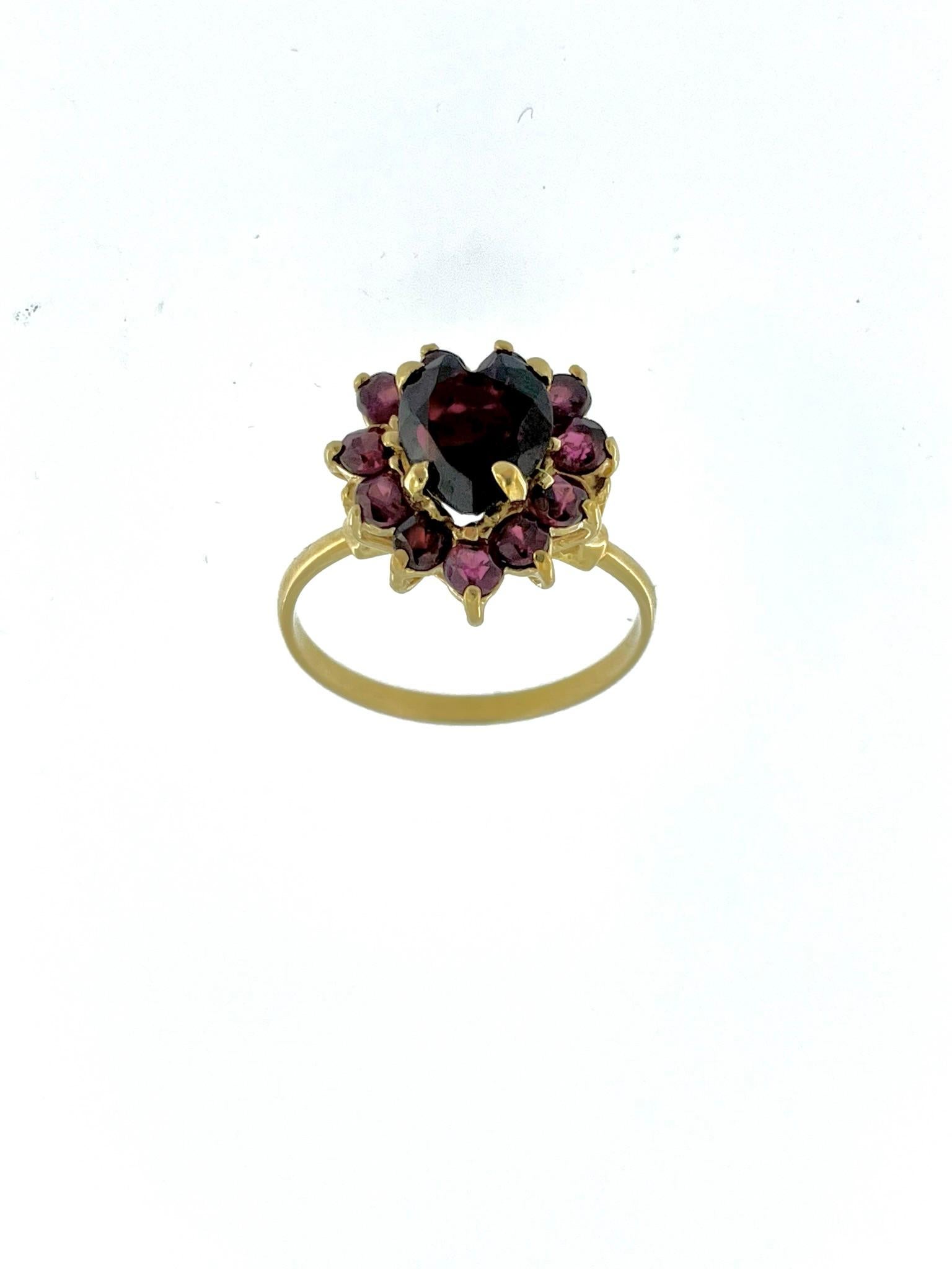 This Vintage Spanish 18kt Yellow Gold Ring with Amethyst is a stunning piece of jewelry that showcases both exquisite craftsmanship and a captivating gemstone. The ring is crafted from 18-karat (18kt) yellow gold, which is known for its rich, warm