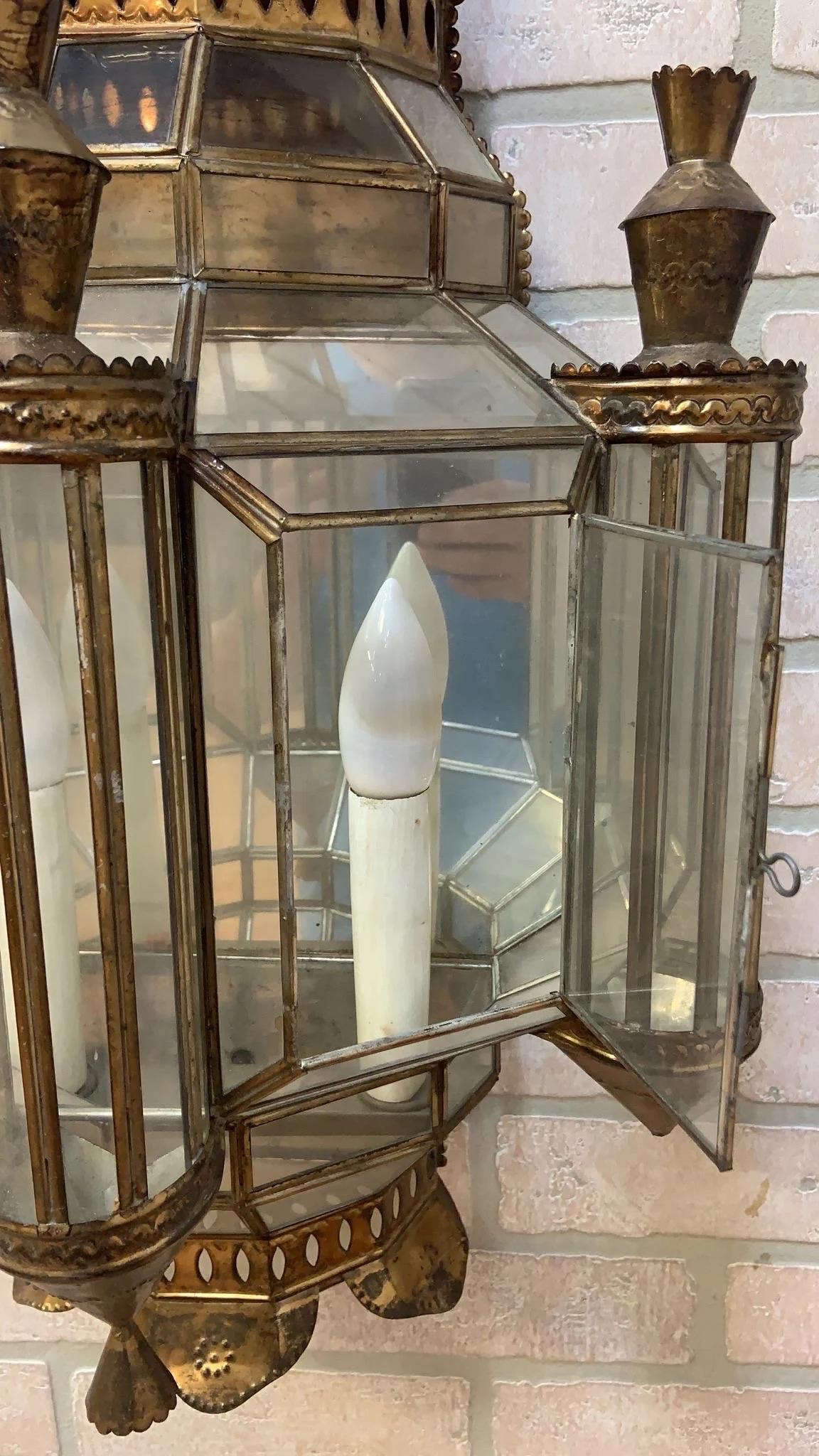 Vintage Spanish Brass with Leaded Glass Exterior Outdoor Lighting Sconce - Pair 

This vintage pair of Spanish exterior sconces contain detailing with brass fretwork and leaded glass. This pair of lights would look beautiful in the entrance to any