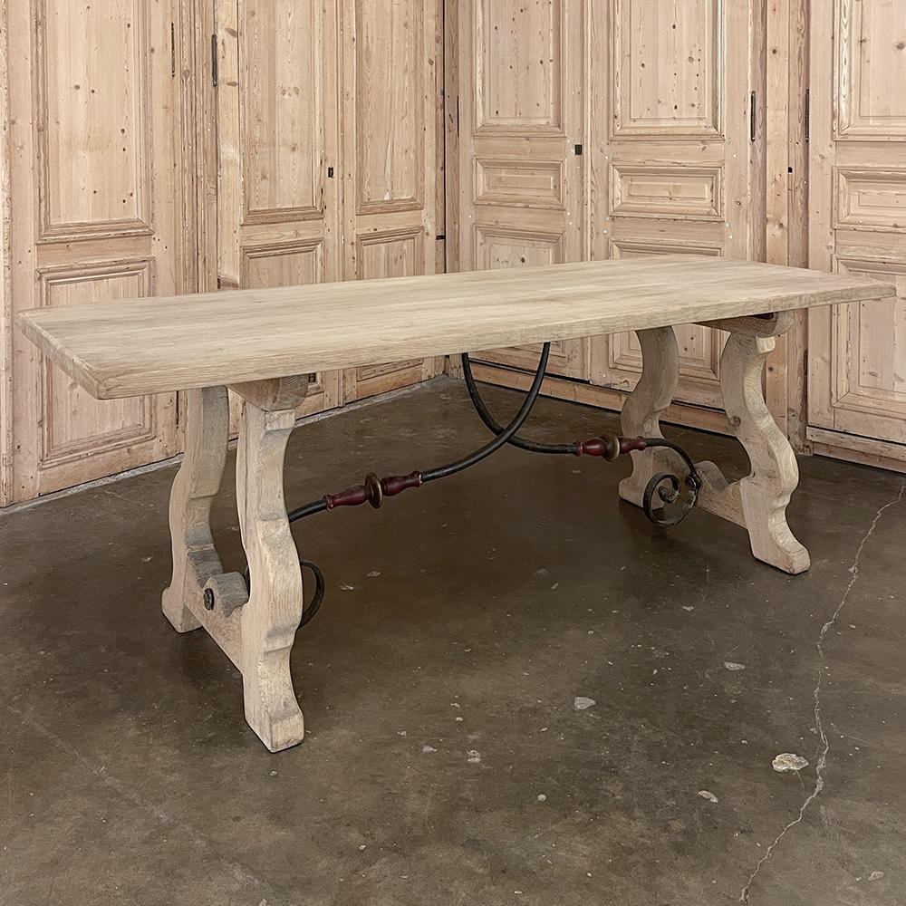 Vintage Spanish Colonial Dining Table with Wrought Iron in Solid Stripped Oak honors the traditional craftsmanship and methods that have been handed down from generation to generation. The band-sawn legs are in a lyre form, with splayed feet for