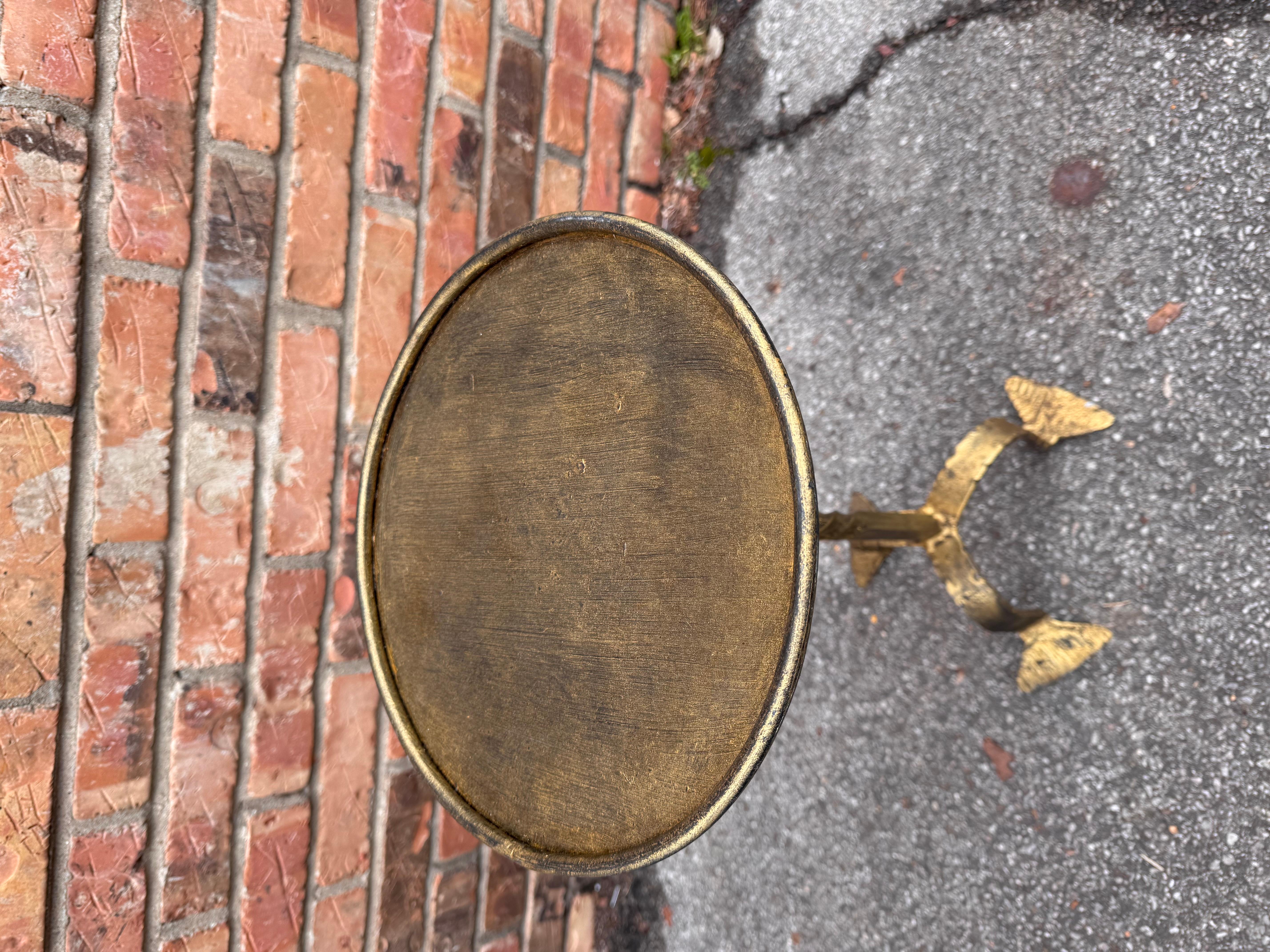 This is wonderful little Spanish made wrought iron drink table with an antiqued gold finish. Contemporary yet antique inspired style for any decor aesthetic. We have several of these listed all have there own unique design, giving them such