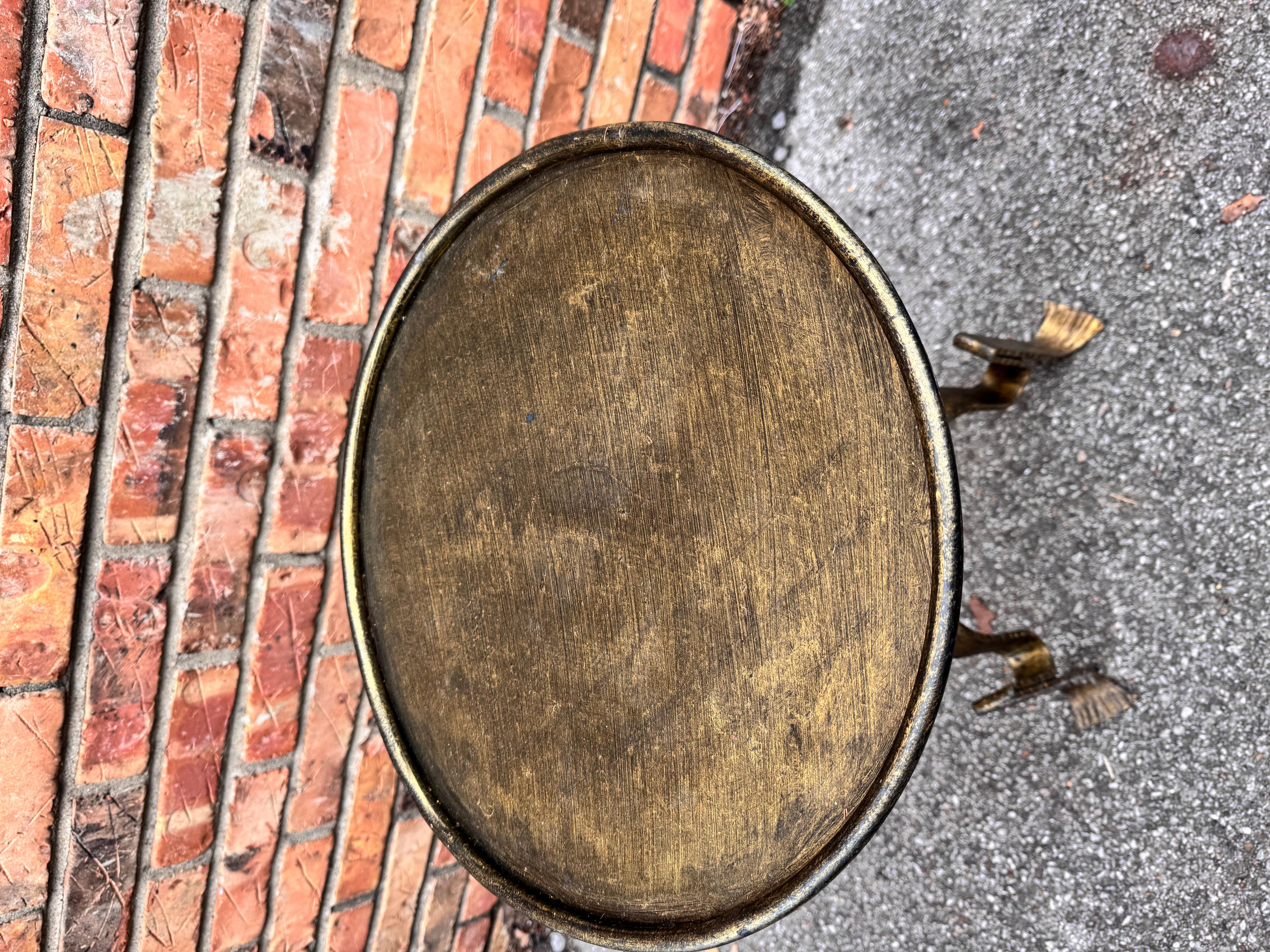 This is wonderful little Spanish made wrought iron drink table with an antiqued gold finish. Contemporary yet antique inspired style for any decor aesthetic. We have several of these listed all have there own unique design, giving them such