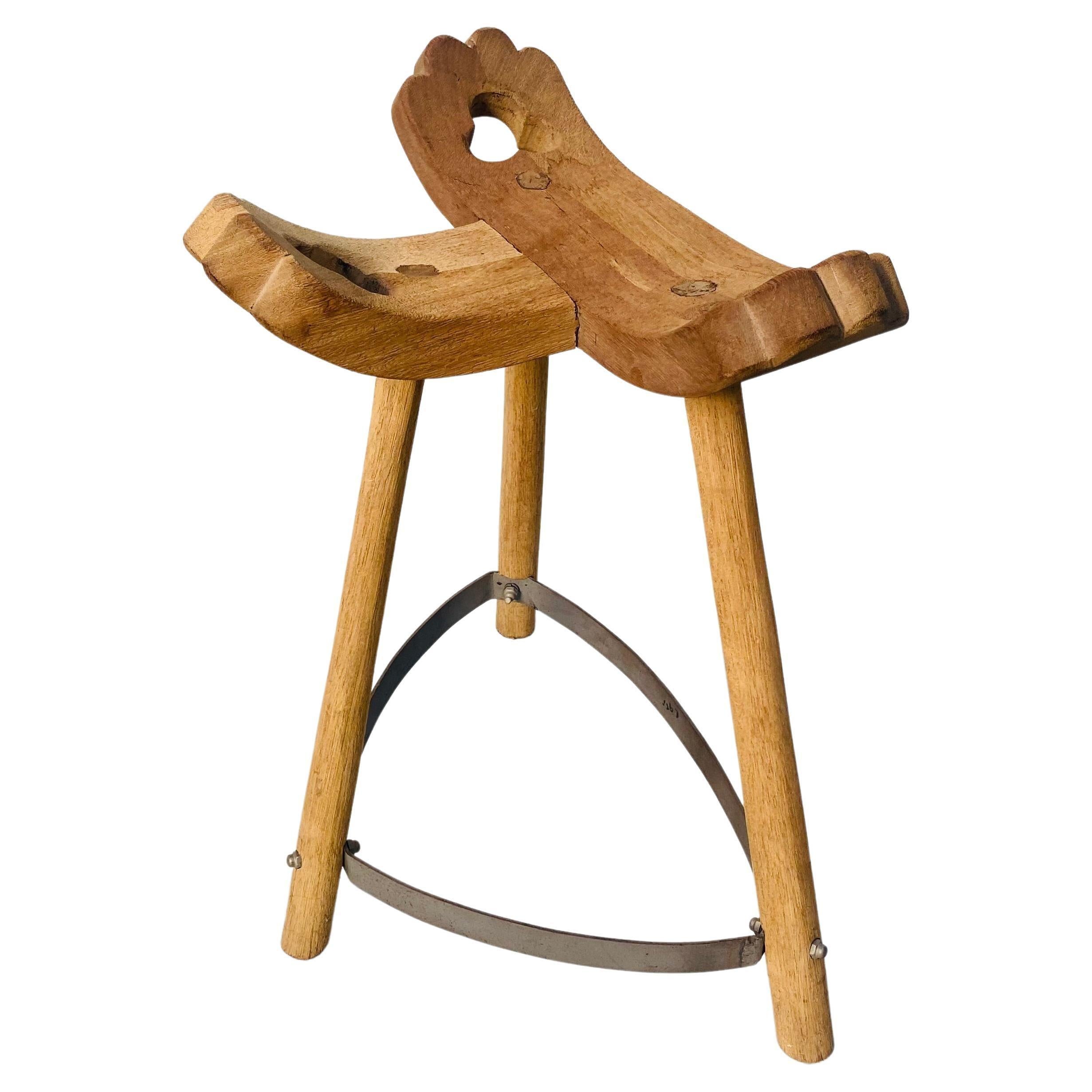 This Spanish handmade Brutalist style stool is made of oak wood and features also a iron footrest. The chair is sandblasted so the natural color of the oak has become visible again. Designed and handmade in the seventies.