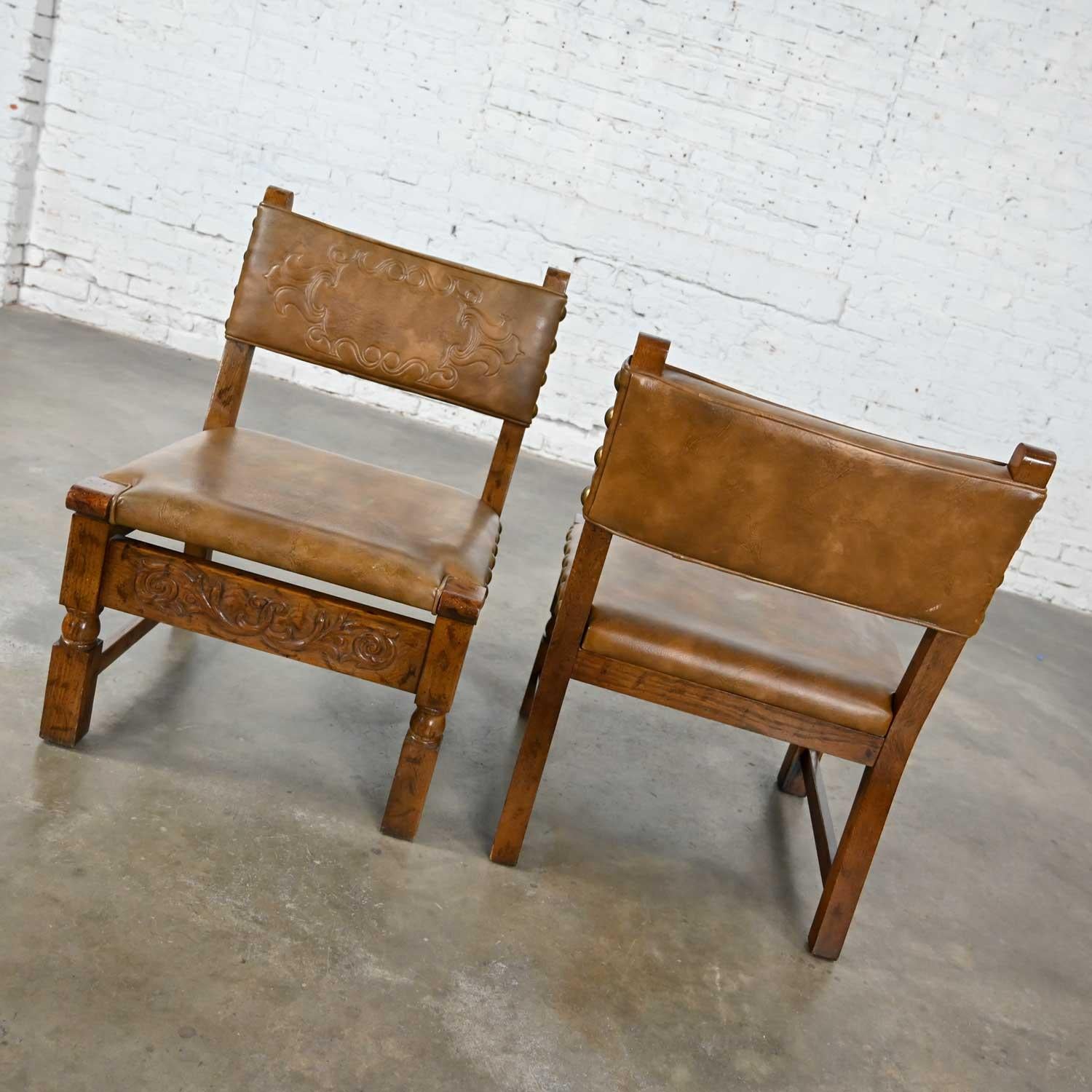 Vintage Spanish Revival Oak Pair of Chairs with Tooled Cognac Faux Leather Seat In Good Condition For Sale In Topeka, KS