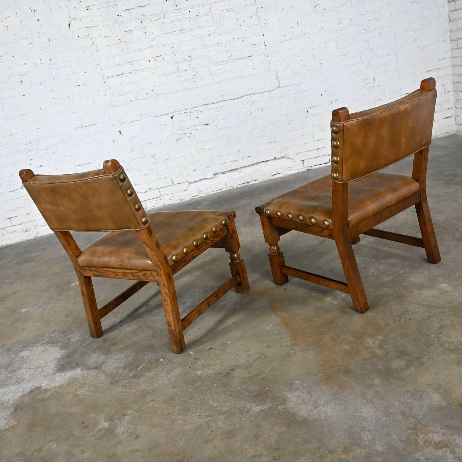 20th Century Vintage Spanish Revival Oak Pair of Chairs with Tooled Cognac Faux Leather Seat For Sale