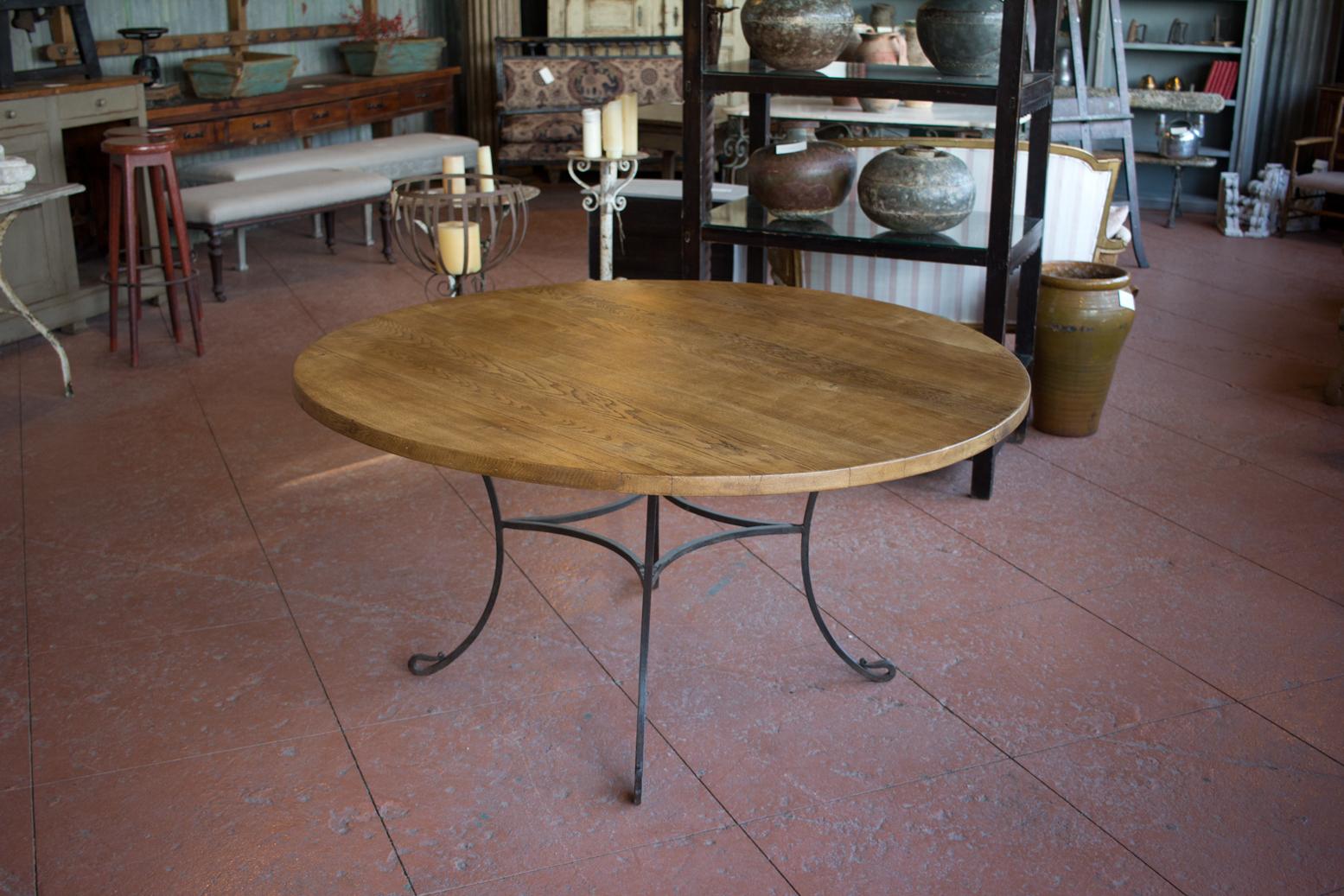 Vintage round table with handcrafted wrought iron base and oak top.